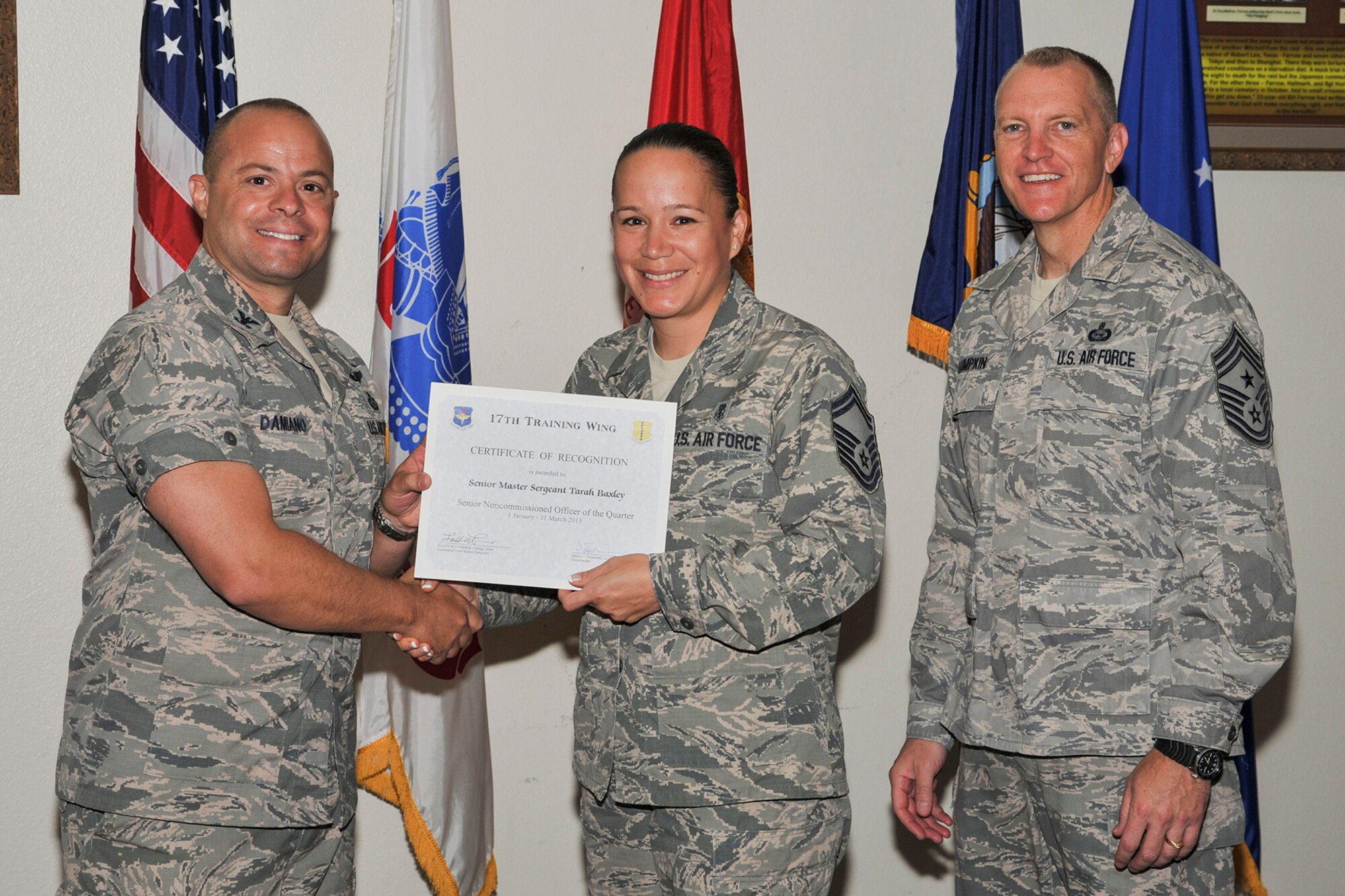 GOODFELLOW AIR FORCE BASE, Texas-- Col. Mark Damiano, 17th Training Wing Commander, and Chief Master Sgt. Scott Lumpkin, 17th TRW Command Chief, present the 17th Training Wing Senior NCO of the Quarter award to Senior Master Sgt. Tarah Baxley, 17th Force Support Squadron, during the wing quarterly awards ceremony  April 23. Baxley also received the Team Goodfellow senior service member of the quarter award. (U.S. Air Force photo/Airman 1st Class Michael Smith)