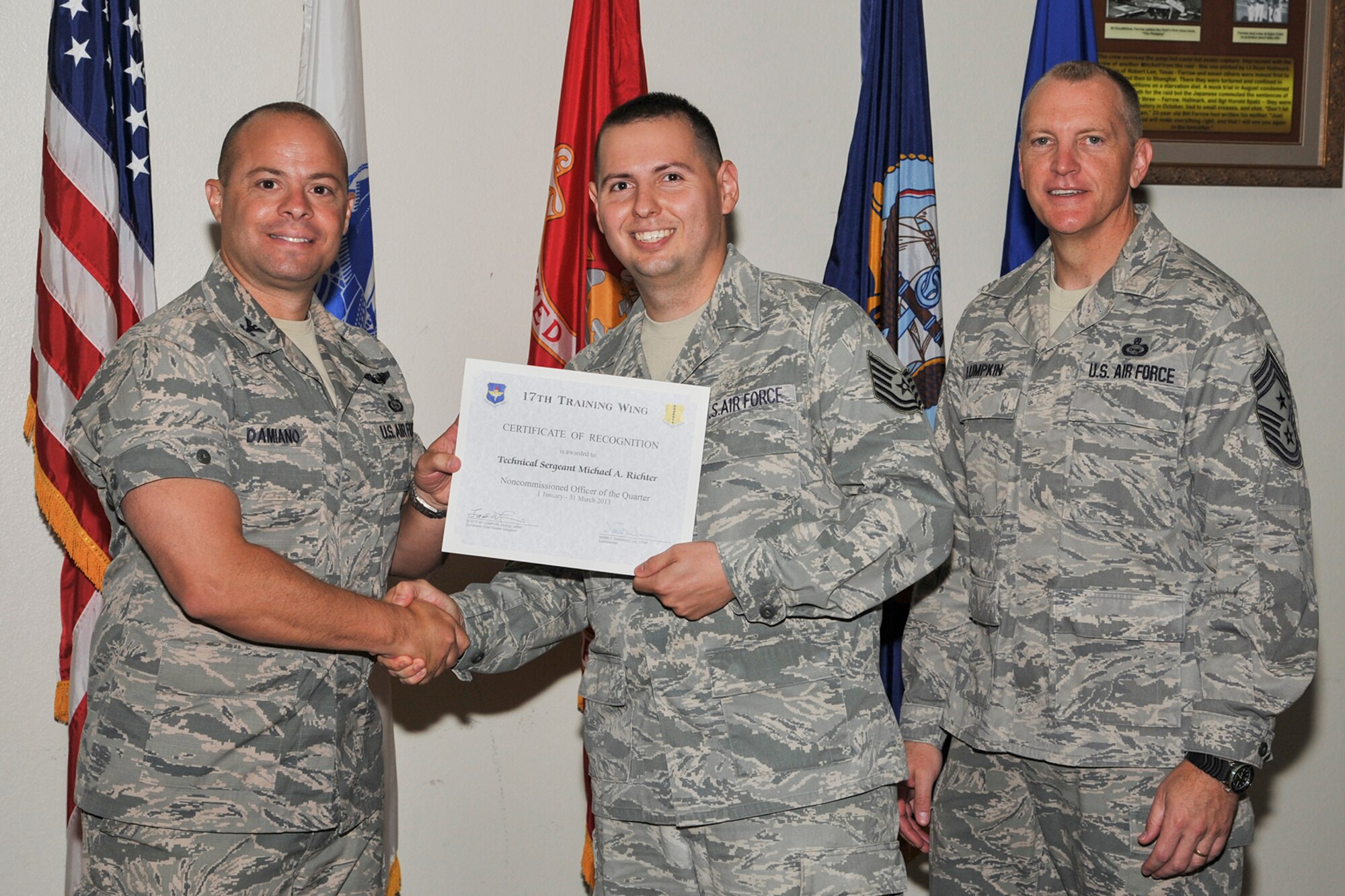 GOODFELLOW AIR FORCE BASE, Texas-- Col. Mark Damiano, 17th Training Wing Commander, and Chief Master Sgt. Scott Lumpkin, 17th TRW Command Chief, present the 17th Training Wing NCO of the Quarter award to Tech. Sgt. Michael Richter, 316th Training Squadron, during the wing quarterly awards ceremony April 23. (U.S. Air Force photo/Airman 1st Class Michael Smith)