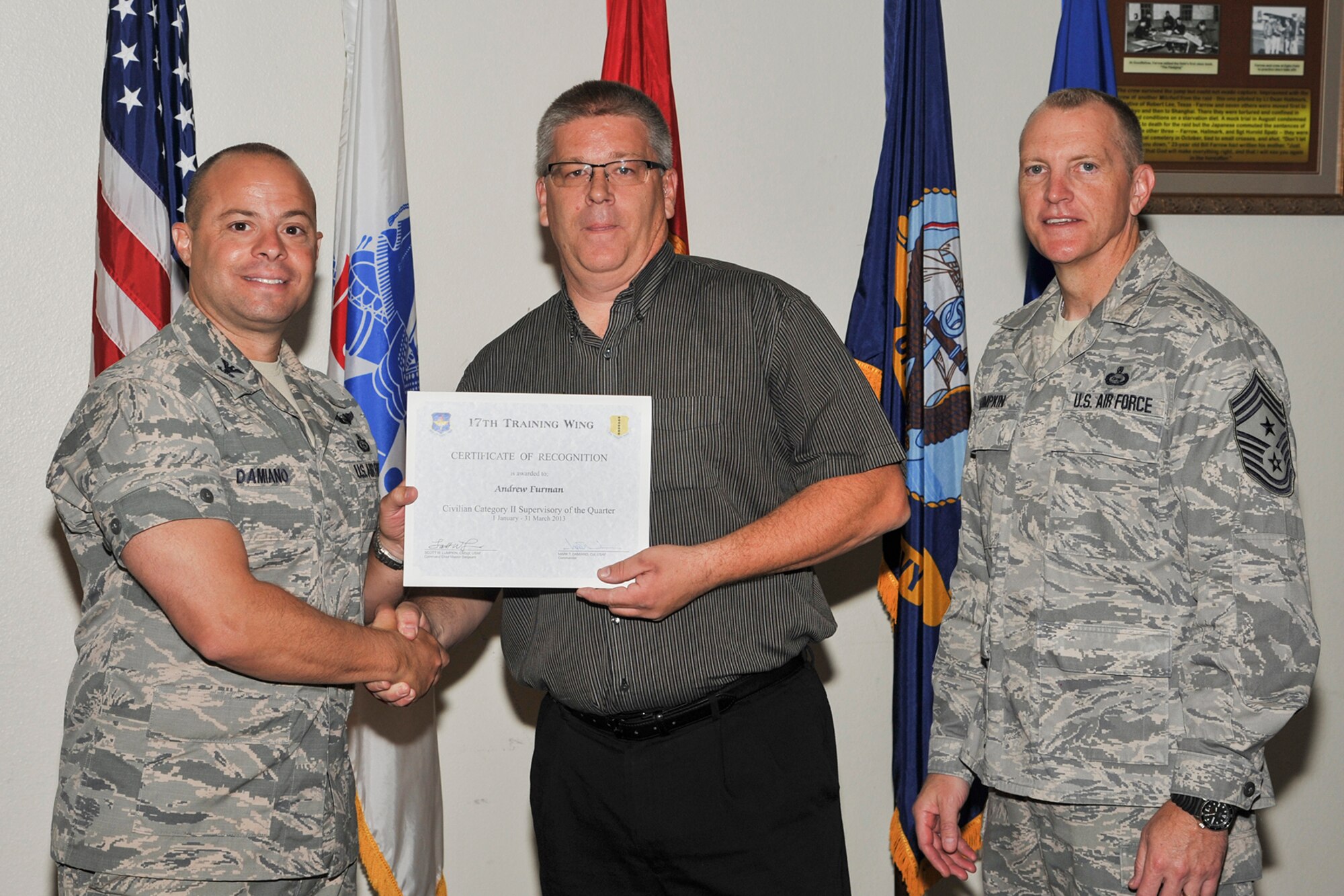 GOODFELLOW AIR FORCE BASE, Texas-- Col. Mark Damiano, 17th Training Wing Commander, and Chief Master Sgt. Scott Lumpkin, 17th TRW Command Chief, present the 17th Training Wing Civilian Supervisor of the Quarter Category II award to Andrew Furman, 17th Force Support Squadron, during the wing quarterly awards ceremony April 23. (U.S. Air Force photo/Airman 1st Class Michael Smith)