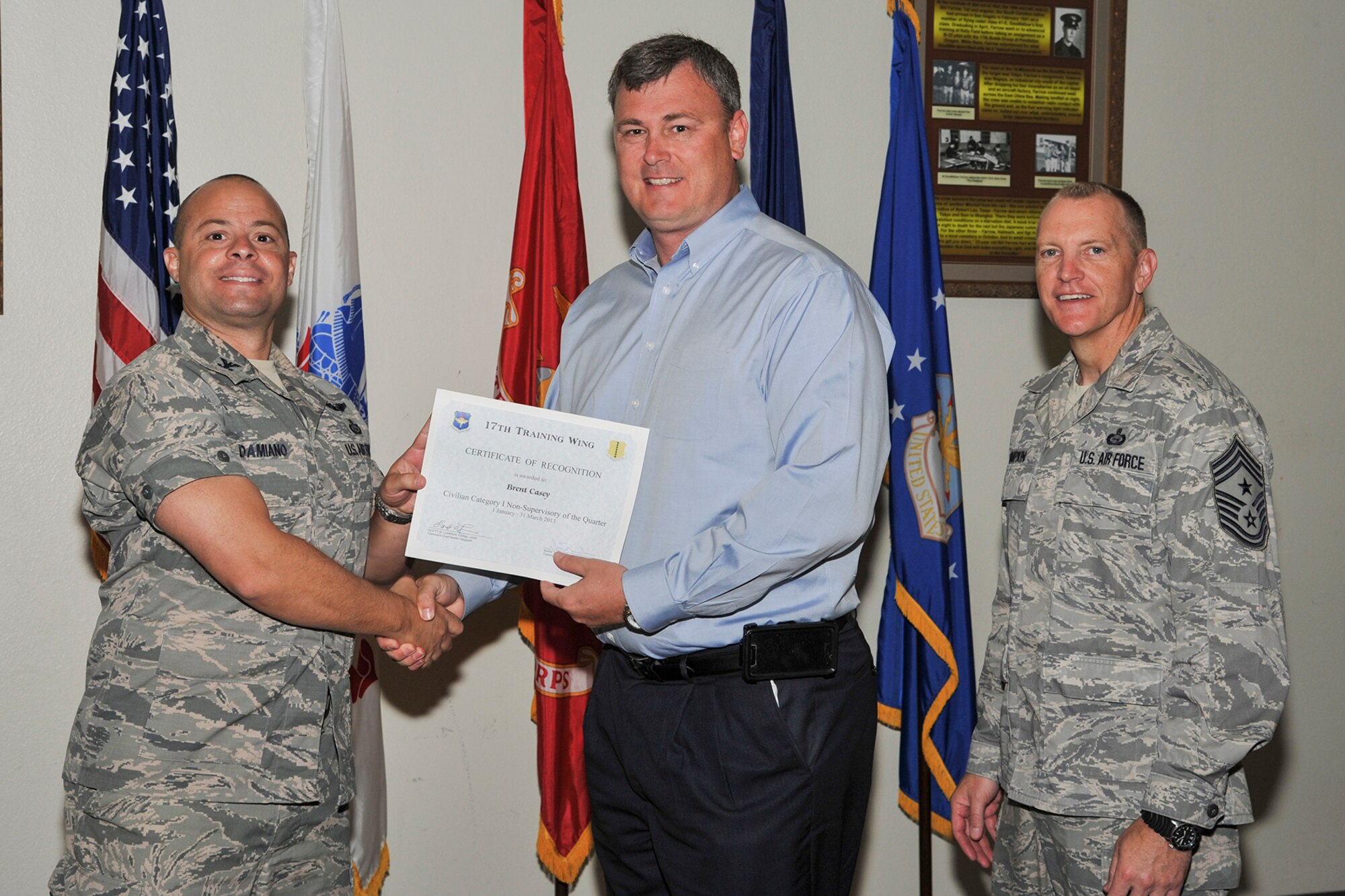 GOODFELLOW AIR FORCE BASE, Texas-- Col. Mark Damiano, 17th Training Wing Commander, and Chief Master Sgt. Scott Lumpkin, 17th TRW Command Chief, present the 17th Training Wing Civilian of the Quarter Category I award to Brent Casey, 17th TRW staff, during the wing quarterly awards ceremony, April 23. (U.S. Air Force photo/Airman 1st Class Michael Smith)