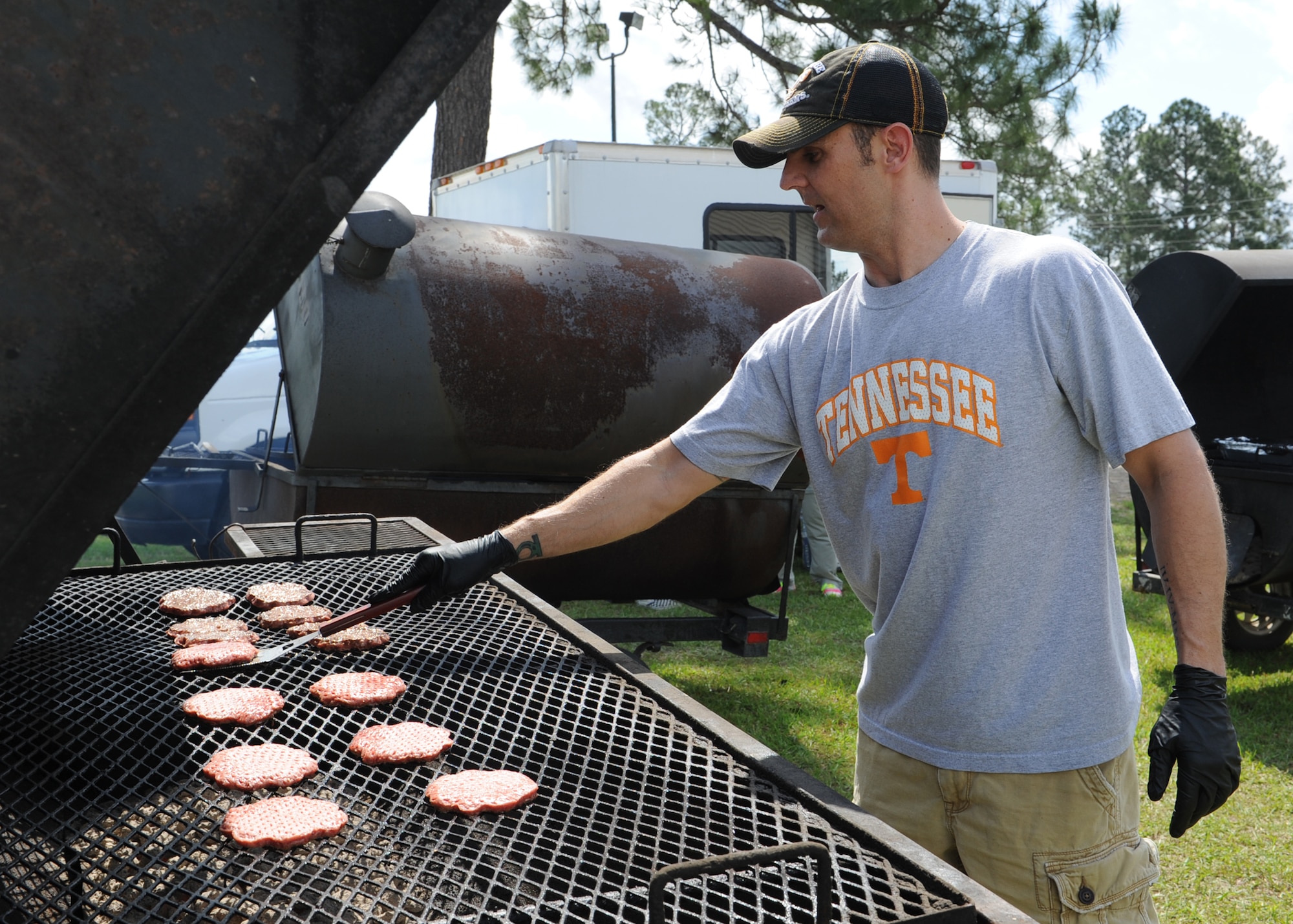 U.S. Air Force Master Sgt. Brian Sadler, 23d Equipment Maintenance Squadron, prepares burgers for the 23d Maintenance Group sports day event at Moody Air Force Base, Ga., April 19, 2013. Along with the cookout, several different sports were included in the festivities. The day ended with leadership participating in a tricycle race. (U.S. Air Force photo by Senior Airman Eileen Meier/Released)