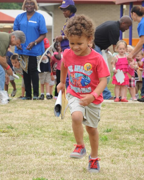 A child from the Child Development Center participates in a recycle relay on Barksdale Air Force Base, La., April 23, 2013. The race was an interactive way to teach children about the three Rs: reduce, reuse and recycle. (U.S. Air Force photo/Senior Airman Sean Martin)