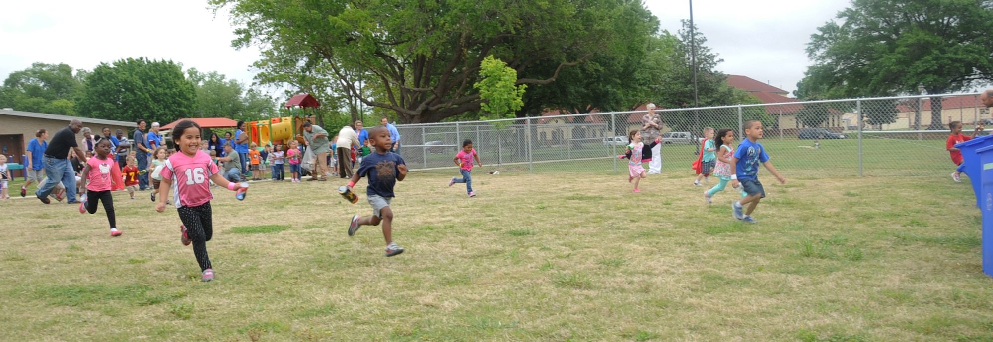 Children from the Child Development Center participate in a recycle relay during an Earth Day ceremony on Barksdale Air Force Base, La., April 23, 2013. The event focused on the three Rs: reduce, reuse and recycle. It taught children the importance and benefits of recycling. (U.S. Air Force photo/Senior Airman Sean Martin)