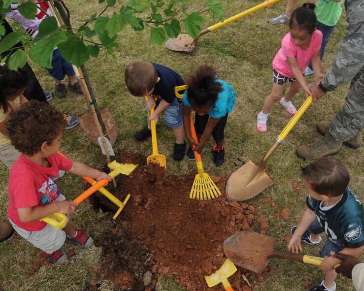 Children from the Child Development Center plant a tree during an Arbor Day ceremony on Barksdale Air Force Base, La., April 23, 2013. Each year, a day is set aside in recognition of Arbor Day, an observance that encourages tree planting, care and preservation. (U.S. Air Force photo/Senior Airman Sean Martin)