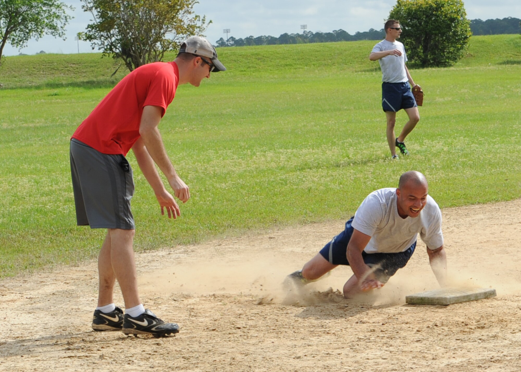 Airmen with the 23d Maintenance Operations Squadron and 23d Equipment Maintenance Squadron compete against each other in a game of softball during the 23d Maintenance Group sports day at Moody Air Force base, Ga., April 19, 2013. Among the festivities were softball, soccer, tug-of-war and volleyball games. (U.S. Air Force photo by Senior Airman Eileen Meier/Released)