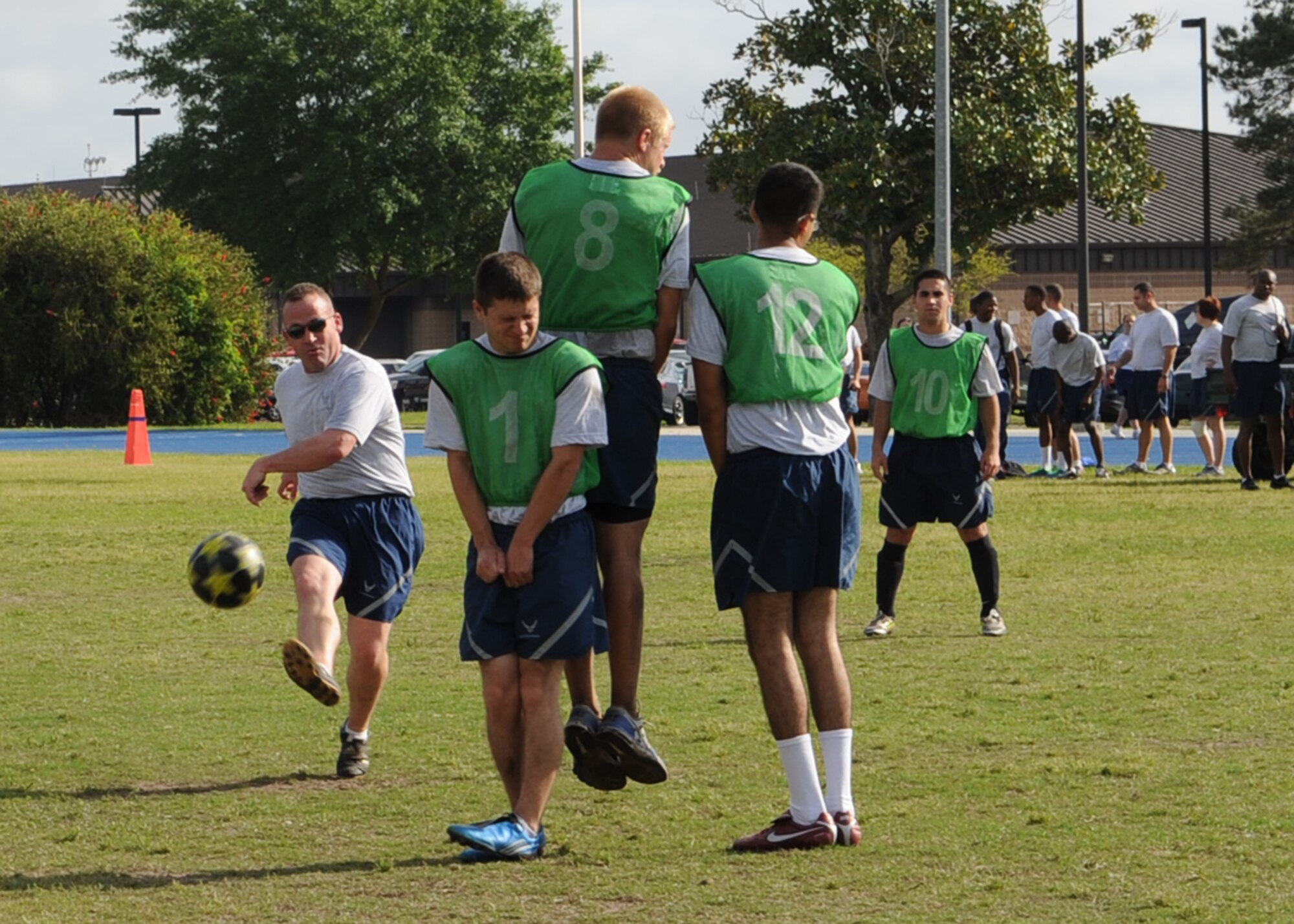 Airmen with the 23d Aircraft Maintenance Squadron and 23d Maintenance Operations Squadron compete against each other in a game of soccer during the 23d Maintenance Group sports day at Moody Air Force Base, Ga., April 19, 2013. After a hot dog and hamburger cookout for members of the 23d MXG, championship games for each sport took place..  (U.S. Air Force photo by Senior Airman Eileen Meier/Released)