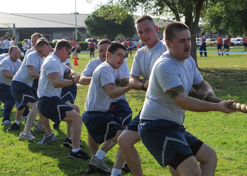 Airmen with the 23d Component Maintenance Squadron compete against the 723d Aircraft Maintenance Squadron in a game of tug-of-war during the 23d Maintenance Group sports day at Moody Air Force Base, Ga., April 19, 2013. Festivities for the day included a cookout, five different sports with championship games and a tricycle race between leadership. (U.S. Air Force photo by Senior Airman Eileen Meier/Released)