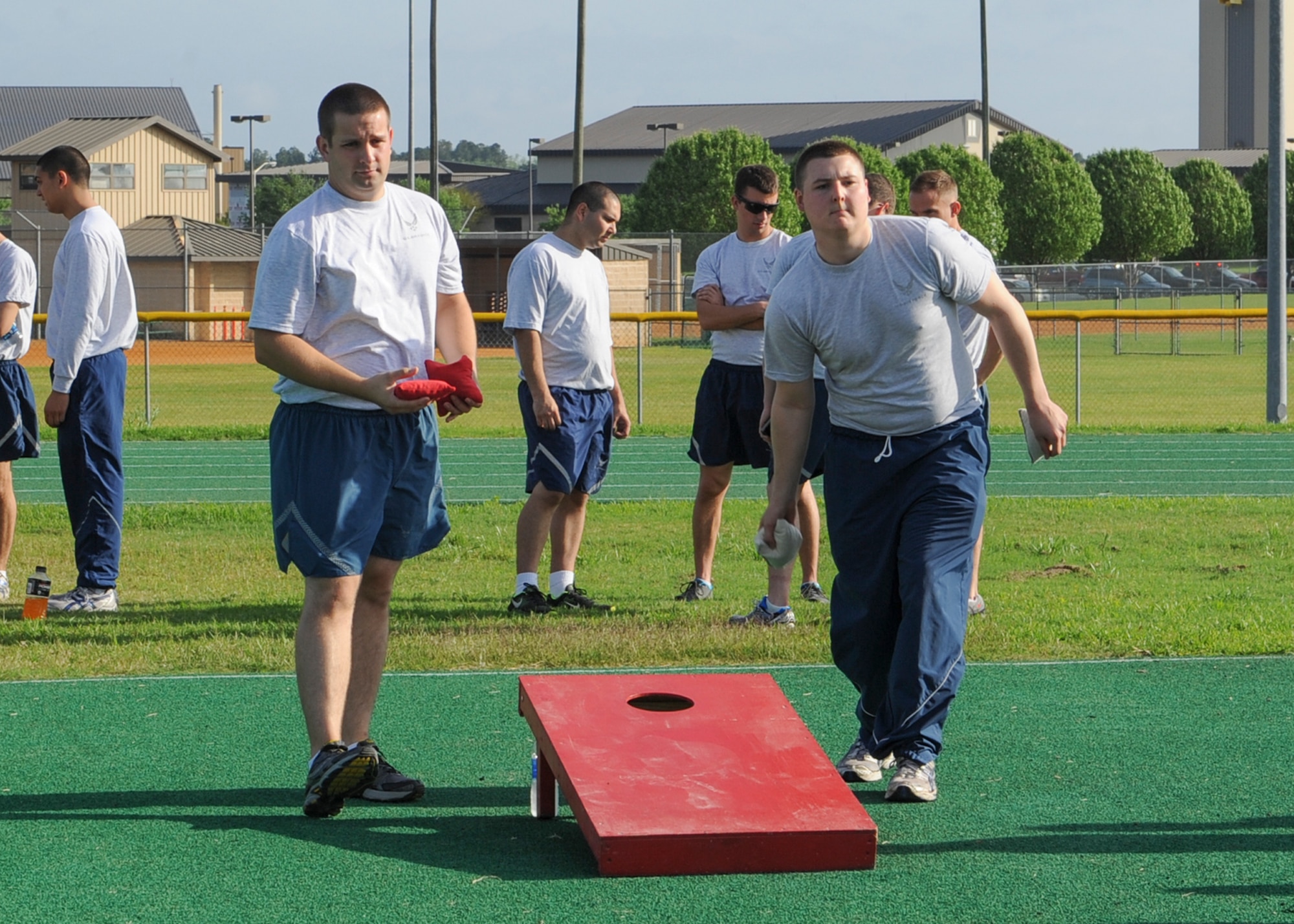 U.S. Air Force Staff Sgt. Loren Worrel and Airman 1st Class Brandon Peters , both from the 723d Aircraft Maintenance Squadron, play a game of bean bag toss during a 23d Maintenance Group sports day event at Moody Air Force Base, Ga., April 19, 2013. Festivities for the day included a cookout, five different sports with championship games and a tricycle race between leadership. (U.S. Air Force photo by Senior Airman Eileen Meier/Released)