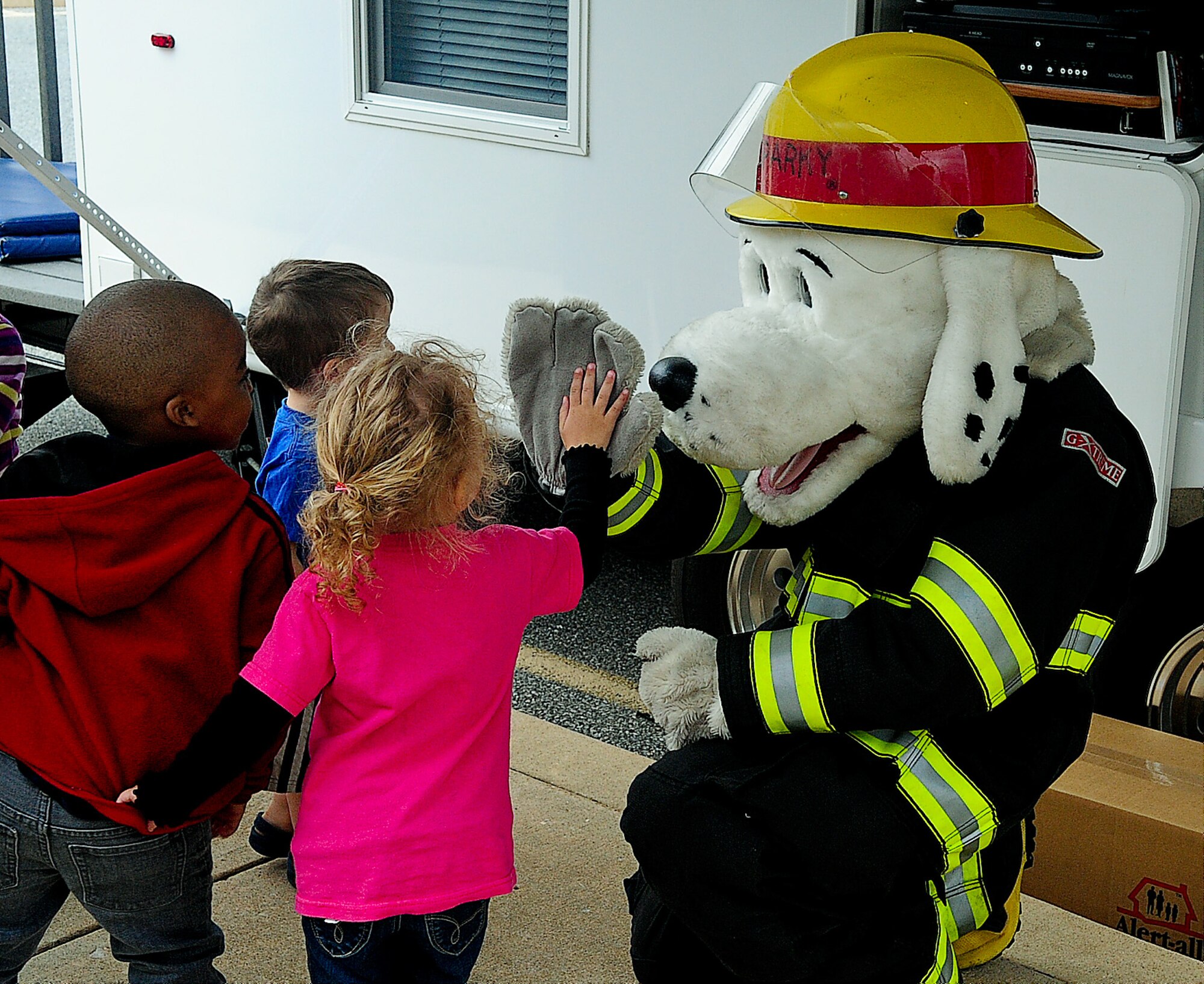 National Fire Protection Association's official mascot Sparky the Fire Dog says hello to  children April 19, 2013, at the Child Development Center on Dover Air Force Base, Del. Sparky teaches kids about fire safety. (U.S. Air Force photo/Airman 1st Class Ashlin Federick)