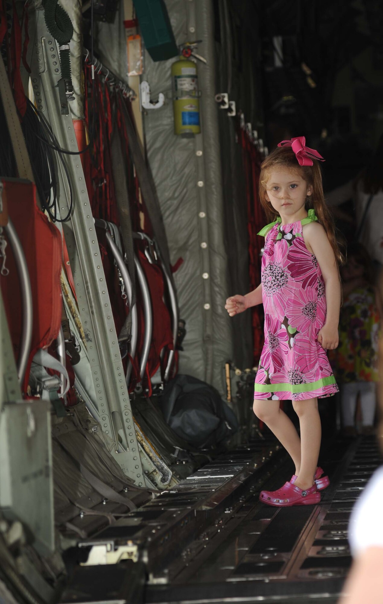Five-year-old Morgan Meoak, daughter of Jamie and Staff Sgt. Christopher Meoak, 338th Training Squadron, looks out the rear door of a C-130J aircraft during a tour April 18, 2013, on the flightline at Keesler Air Force Base, Miss.  Classmates of Morgan from the child development center also toured the aircraft to learn about things that fly.  (U.S. Air Force photo by Kemberly Groue)