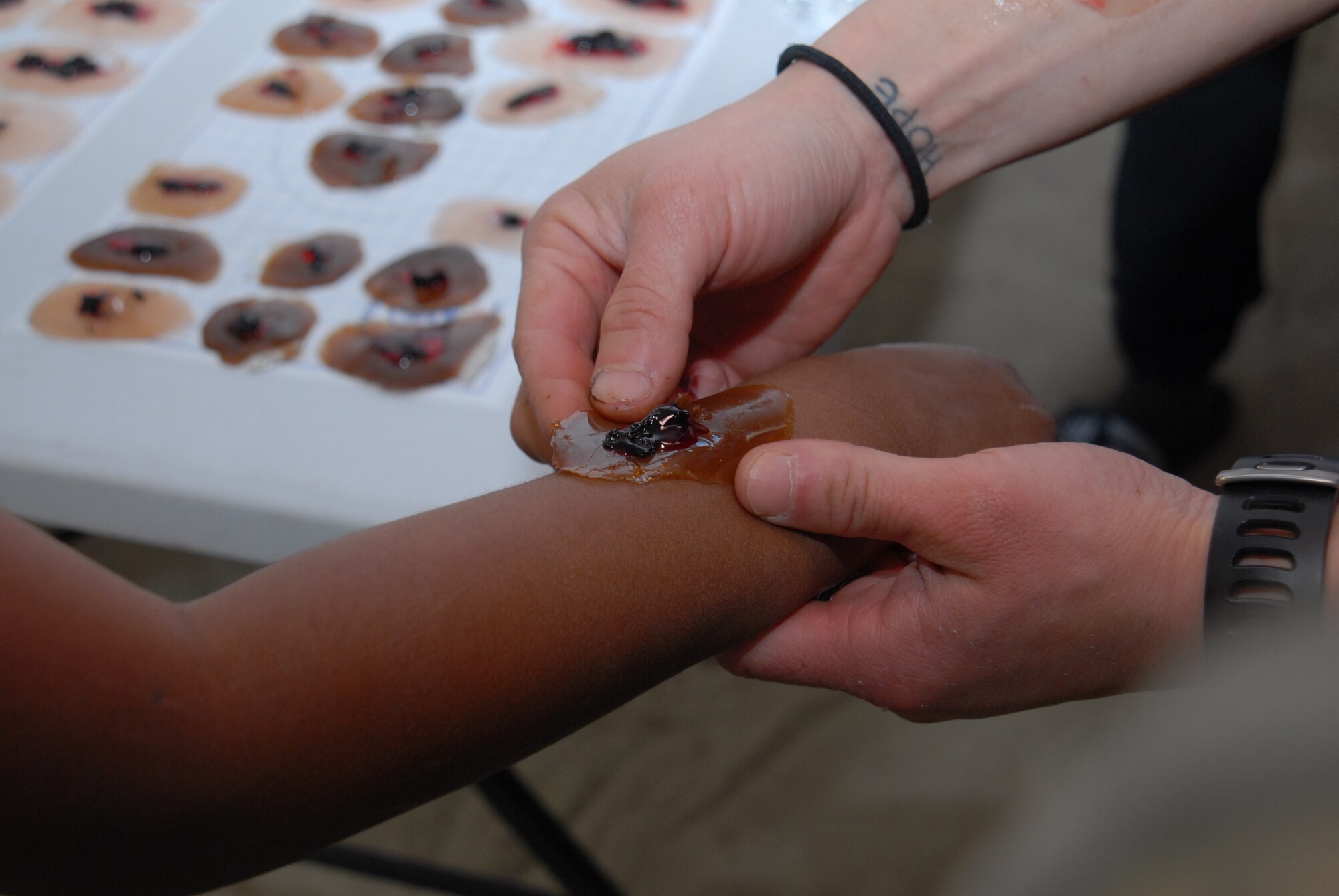 GOODFELLOW AIR FORCE BASE, Texas – The “enlistees” receive artificial wounds in the 17th Medical Group tent on the training grounds, here, April 20, during Operation Kids Investigating Deployment Services. The annual event gave children the chance to experience deployment for a better understanding of what their parents do when deployed. (U.S. Air Force photo/ Airman 1st Class Breonna Fields) 