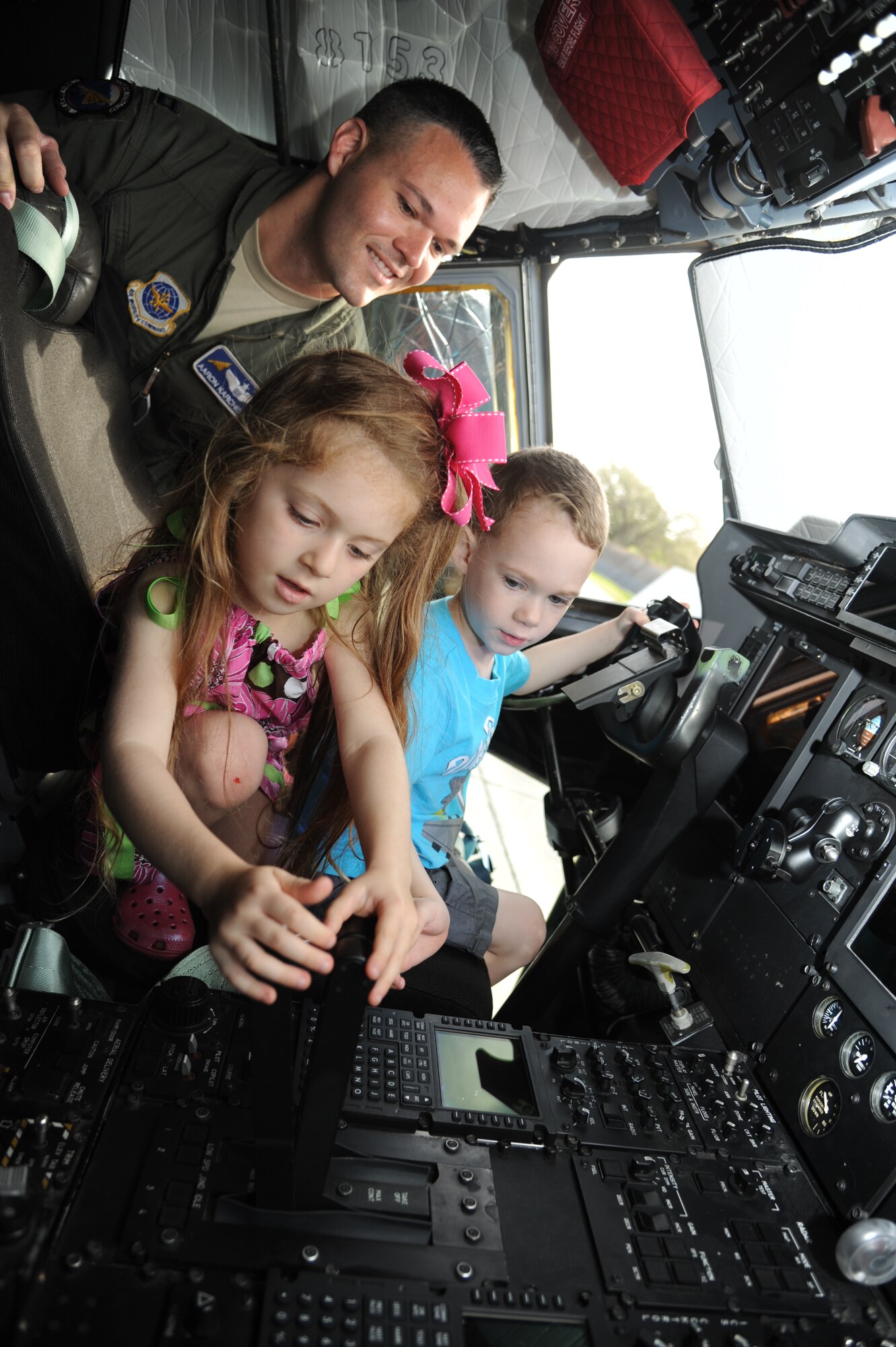 Morgan Meoak, 5, and Ryan Karcher, 3, receive a hands-on experience inside the cockpit of a C-130J aircraft under the watchful eye of Ryan’s dad, Capt. Aaron Karcher, 345th Airlift Squadron, during a tour April 18, 2013, on the flightline at Keesler Air Force Base, Miss.  Classmates of Morgan and Ryan from the child development center also toured the aircraft to learn about thing that fly.  Morgan is the daughter of Jamie and Staff Sgt. Christopher Meoak, 338th Training Squadron.  (U.S. Air Force photo by Kemberly Groue)