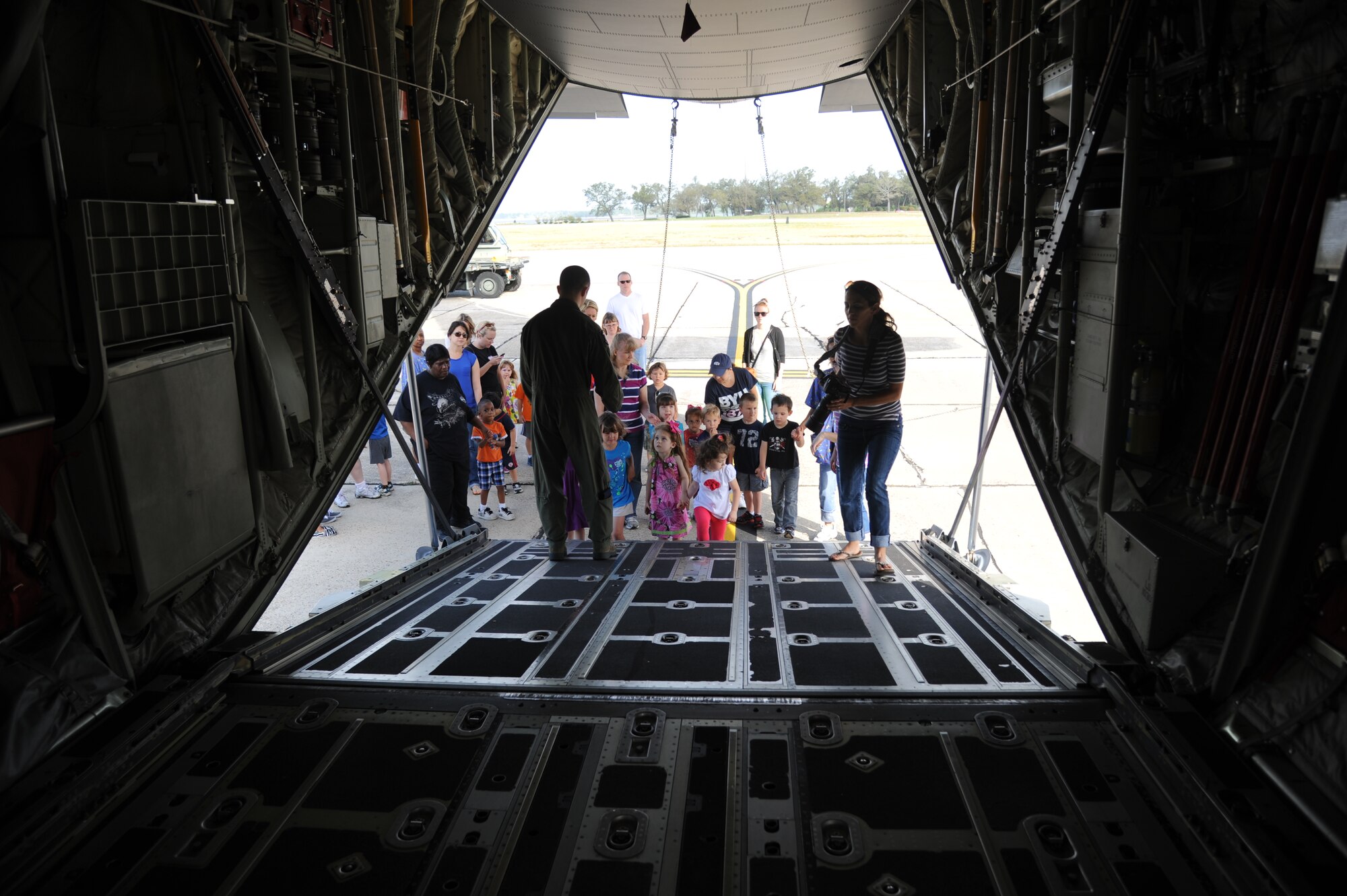 Children from the child development center enter the rear of a C-130J aircraft for a tour April 18, 2013, on the flightline at Keesler Air Force Base, Miss., to learn about thing that fly.  (U.S. Air Force photo by Kemberly Groue)