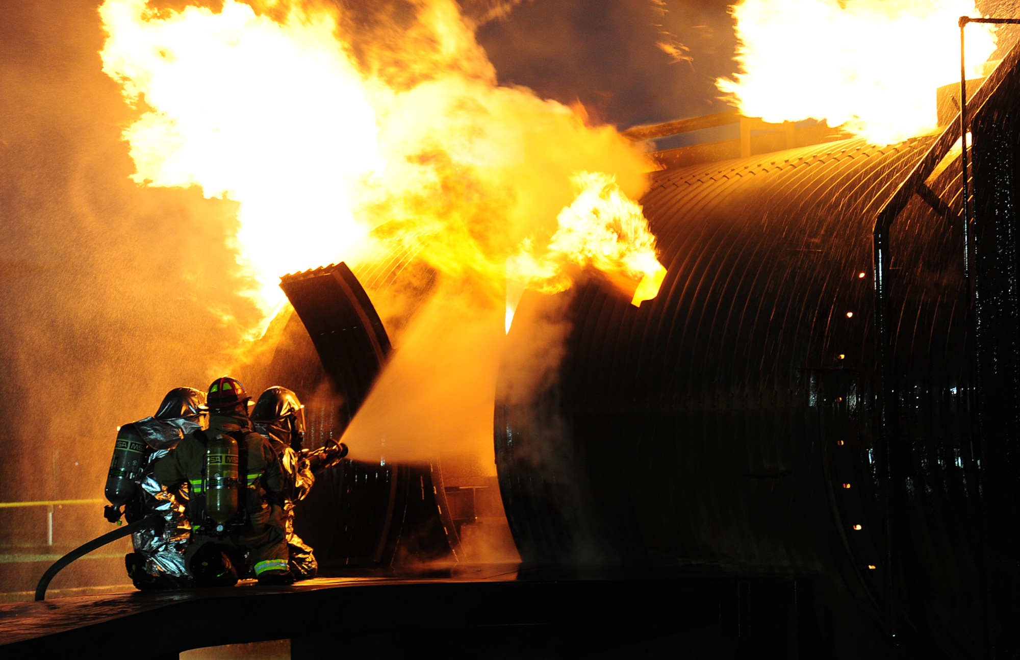 Fairchild Firefighters put out the fire in a simulated aircraft during live fire training at Fairchild Air Force Base, Wash., April 17, 2013. Firefighters are required to conduct this training twice a year to stay proficient on their skills. (U.S. Air Force photo by Airman 1st Class Janelle Patiño/Released)