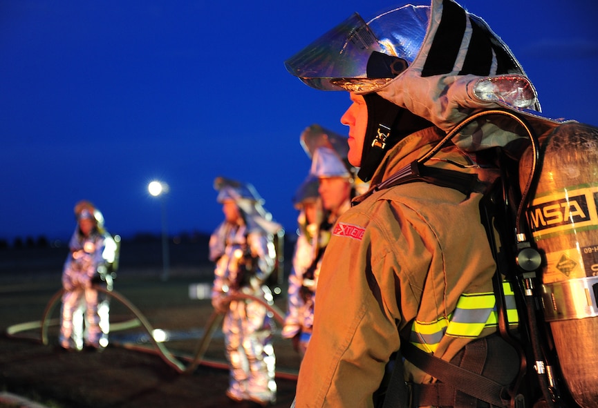 Airman 1st Class Wade Hetland observes as other firefighters enter an aircraft simulator during live fire training at Fairchild Air Force Base, Wash., April 17, 2013. All members of the team must be ready to assist the entering crews at a moment's notice.(U.S. Air Force photo/Airman 1st Class Janelle Patiño)