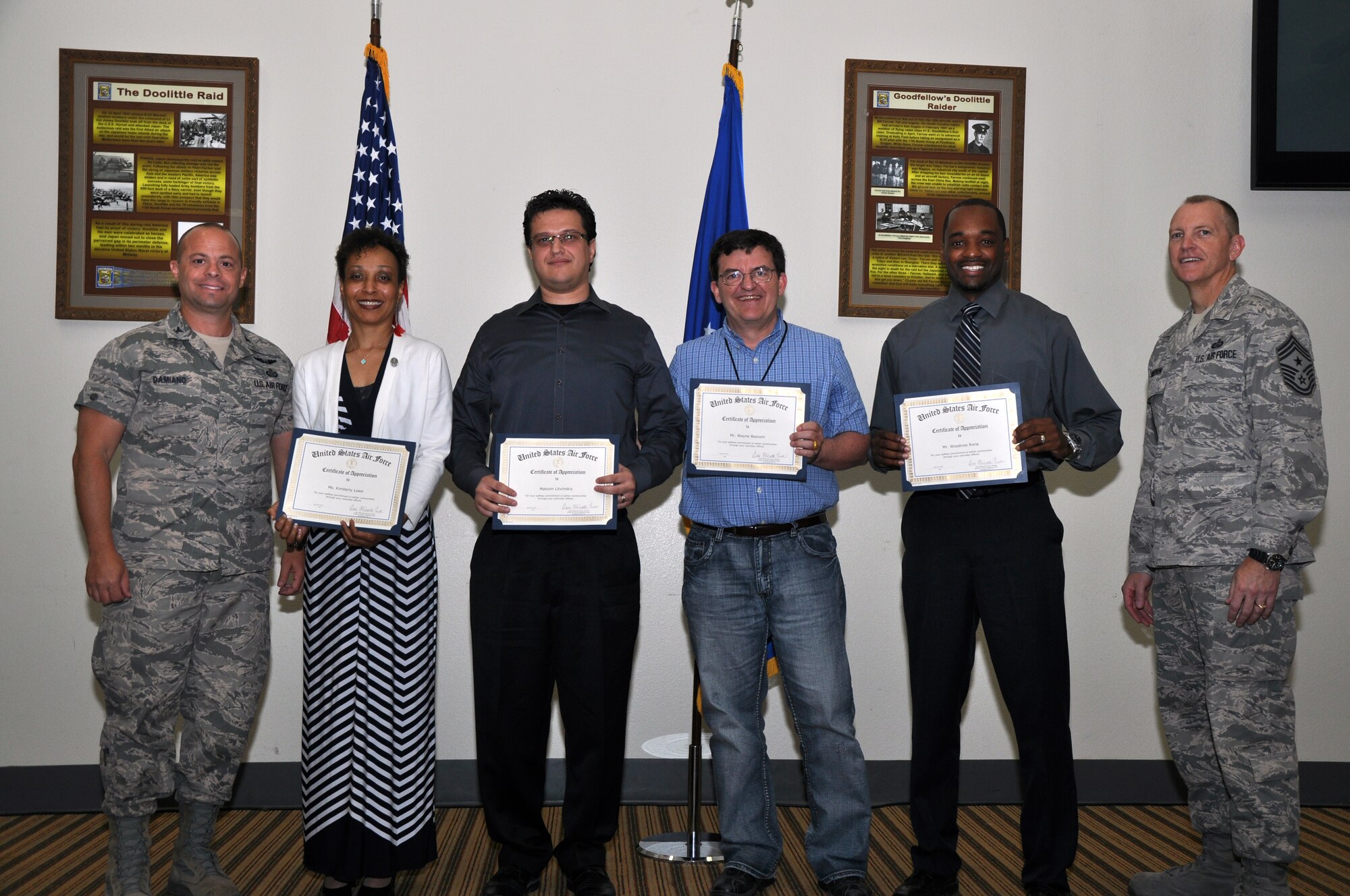 GOODFELLOW AIR FORCE BASE, Texas – Col. Mark Damiano, 17th Training Wing Commander and Chief Master Sgt. Scott Lumpkin, 17th Training Wing Command Chief, pose with the Upward Youth Volunteers after they received an award for the President’s Volunteer Service Award Silver Medal at the Event Center here, April 18. Volunteers receive this award for volunteering 250 to 499 hours of their time. (U.S. Air Force photo/ Airman 1st Class Joshua Edwards)