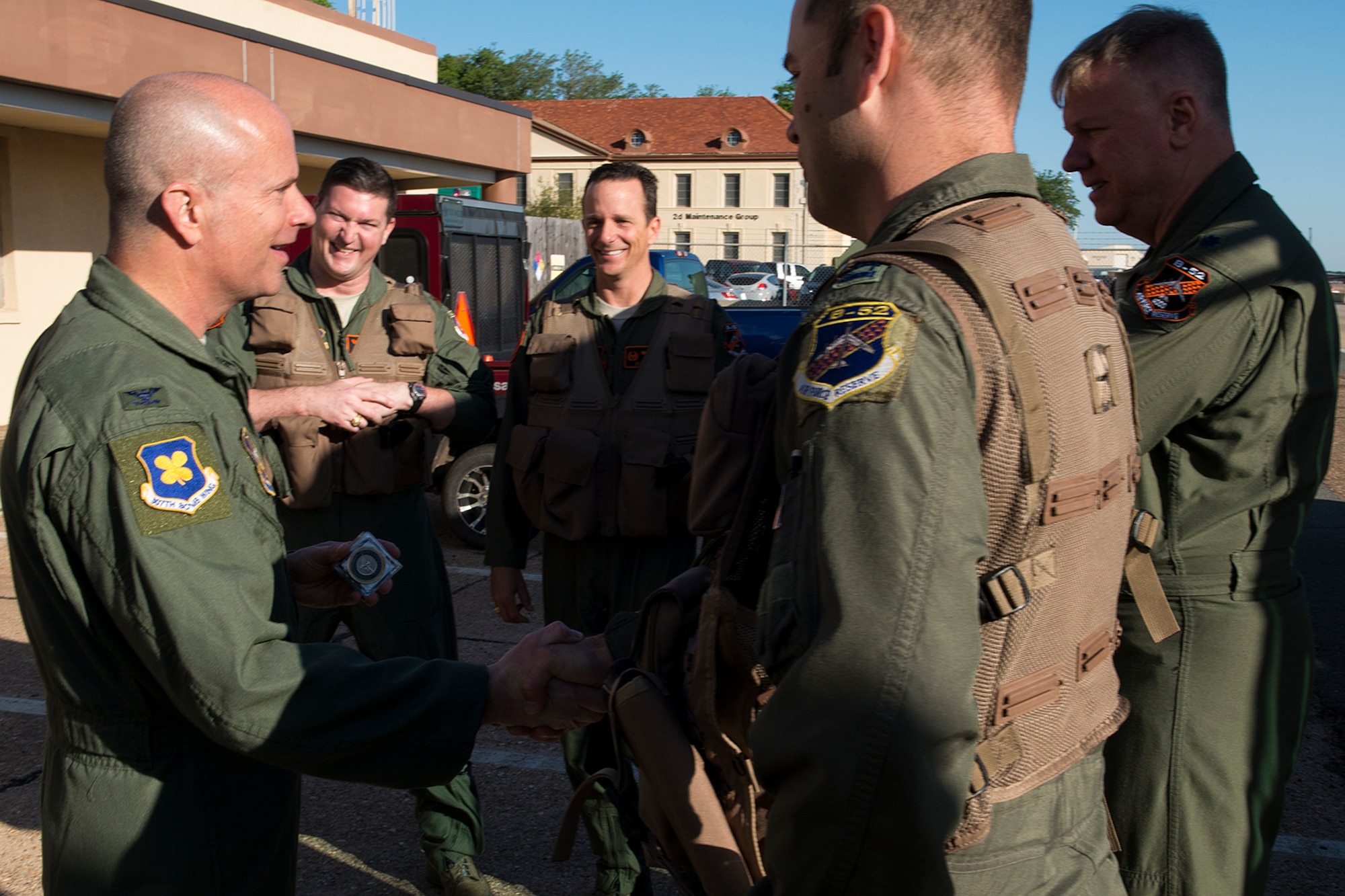 U.S. Air Force Col. Jonathan Ellis, 307th Bomb Wing commander, "coins" aircrew prior to their leaving Barksdale Air Force Base, La., for Minot AFB, N.D., April 19, 2013. The aircrew is assigned to the 343rd Bomb Squadron, and is participating in a nuclear exercise after becoming the first Air Force Reserve squadron to receive their nuclear certification. (U.S. Air Force photo by Master Sgt. Greg Steele/Released)