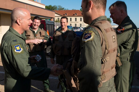 U.S. Air Force Col. Jonathan Ellis, 307th Bomb Wing commander, "coins" aircrew prior to their leaving Barksdale Air Force Base, La., for Minot AFB, N.D., April 19, 2013. The aircrew is assigned to the 343rd Bomb Squadron, and is participating in a nuclear exercise after becoming the first Air Force Reserve squadron to receive their nuclear certification. (U.S. Air Force photo by Master Sgt. Greg Steele/Released)