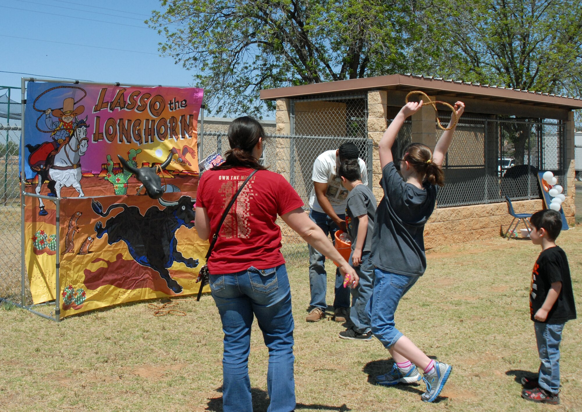 GOODFELLOW AIR FORCE BASE, Texas—A youth celebrates after hooking a rope on the longhorn during Children’s Fest, at the Youth Center baseball field, here, April 20. Children’s Fest is a 26 year Goodfellow tradition. (U.S. Air Force photo/1st Lt. Leanne Hedgepeth)