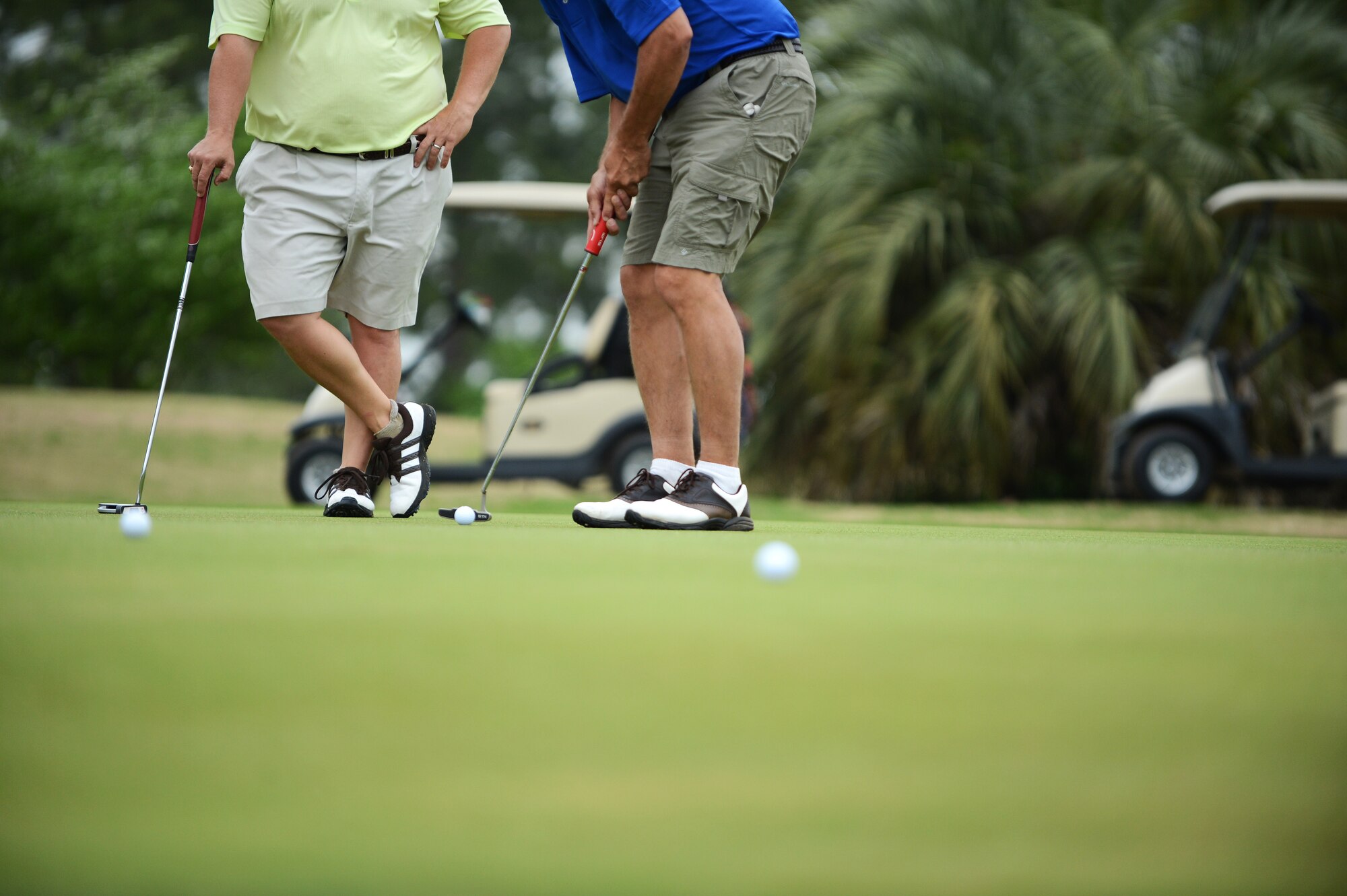 Jerry Allred (left), Crosswell executive director, watches as his teammate  Mark Webster attempts to putt for par during the  “5th Annual John K. Crosswell Charity Golf Tournament” held at Shaw Air Force Base, S.C., April 19, 2013. The tournament was held to raise money for the Crosswell organization whose goal is to provide a loving, nurturing environment for children and families in need. All the proceeds from the event went to further this cause. (U.S. Air Force photo by Airman 1st Class Daniel Blackwell/Released)