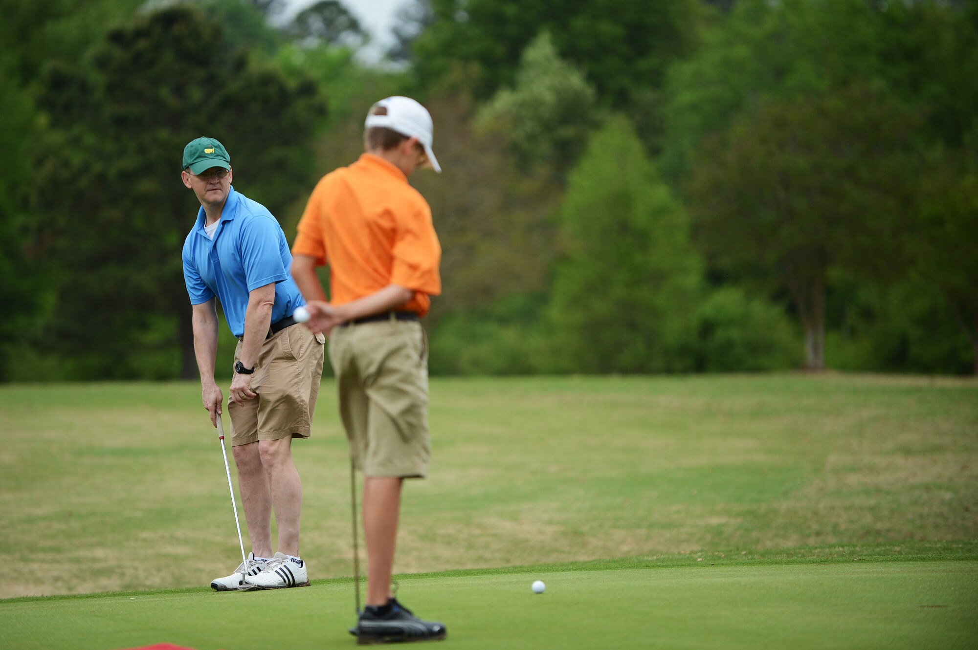 Lt. Col. Robert Snodgrass (left), 20th Mission Support Group deputy command, and Keith Kellner watch as his ball approaches the hole during the “5th Annual John K. Crosswell Charity Golf Tournament” held at Shaw Air Force Base, S.C., April 19, 2013. The tournament was held to raise money for the Crosswell organization whose goal is to provide a loving, nurturing environment for children and families in need. All the proceeds from the event went to further this cause. (U.S. Air Force photo by Airman 1st Class Daniel Blackwell/Released)