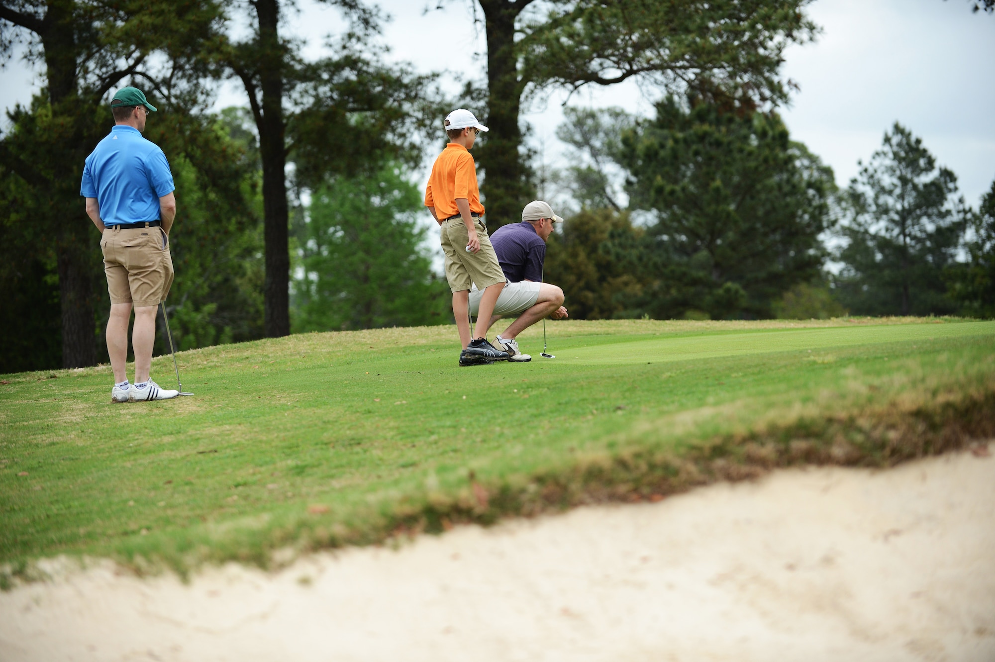 (From left) Lt. Col. Robert Snodgrass, 20th Mission Support Group deputy commander, and Keith Kellner watch as Col. Scott Arcuri, 20th MSG commander lines up his shot during the “5th Annual John K. Crosswell Charity Golf Tournament” at Shaw Air Force Base, S.C., April 19, 2013. The tournament was held to raise money for the Crosswell organization whose goal is to provide a loving, nurturing environment for children and families in need. The proceeds from the event went to further this cause. (U.S. Air Force photo by Airman 1st Class Daniel Blackwell/Released)