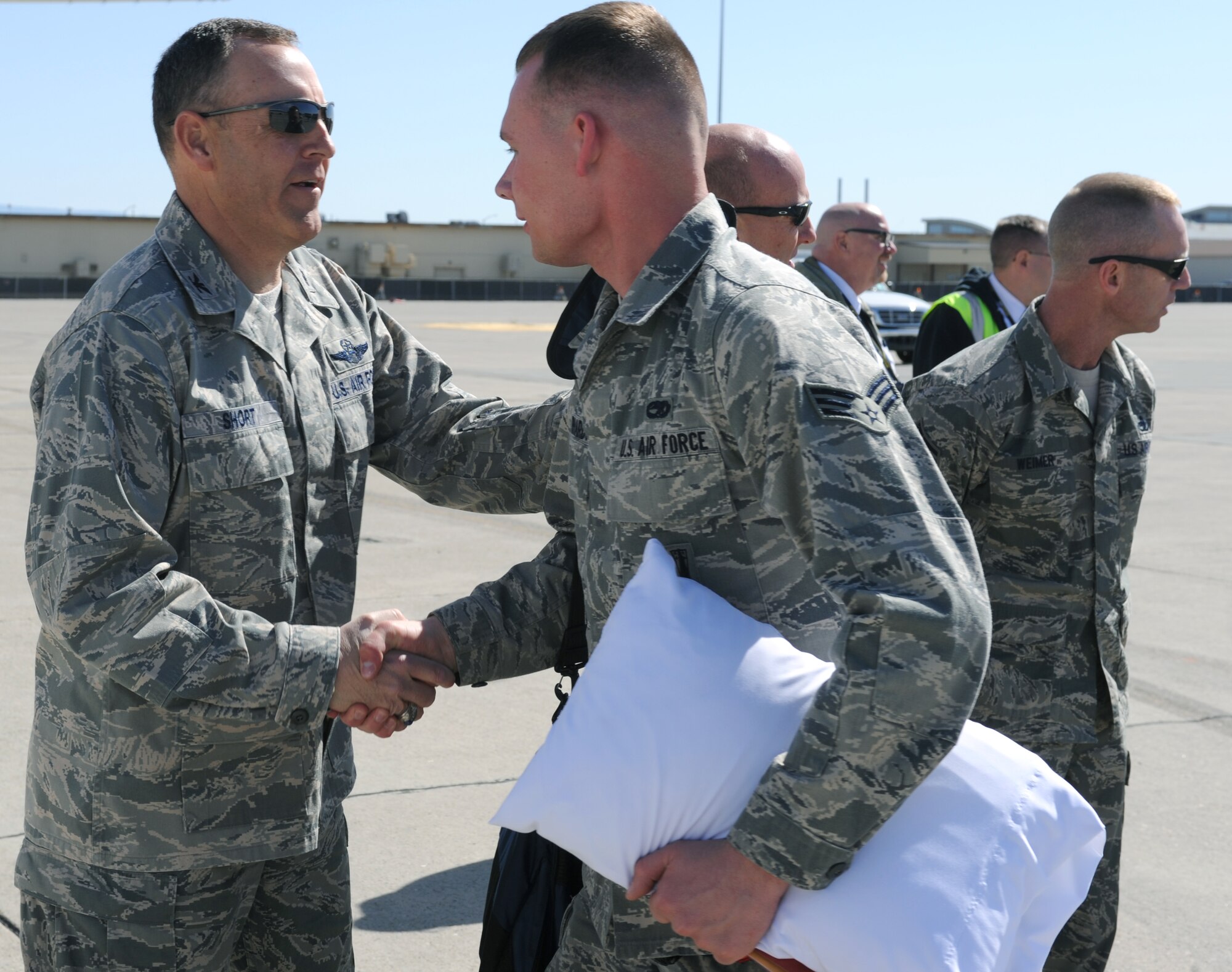 U.S. Air Force Col. Chris Short, 366th Fighter Wing commander, shakes the hand of a deploying Airman before he boards a plane April 23, 2013, at Mountain Home Air Force Base, Idaho. Several months of training has been conducted in preparation for this specific mission and Airmen are ready to take on the challenge. (U.S. Air Force photo by Senior Airman Benjamin Sutton/Released) 