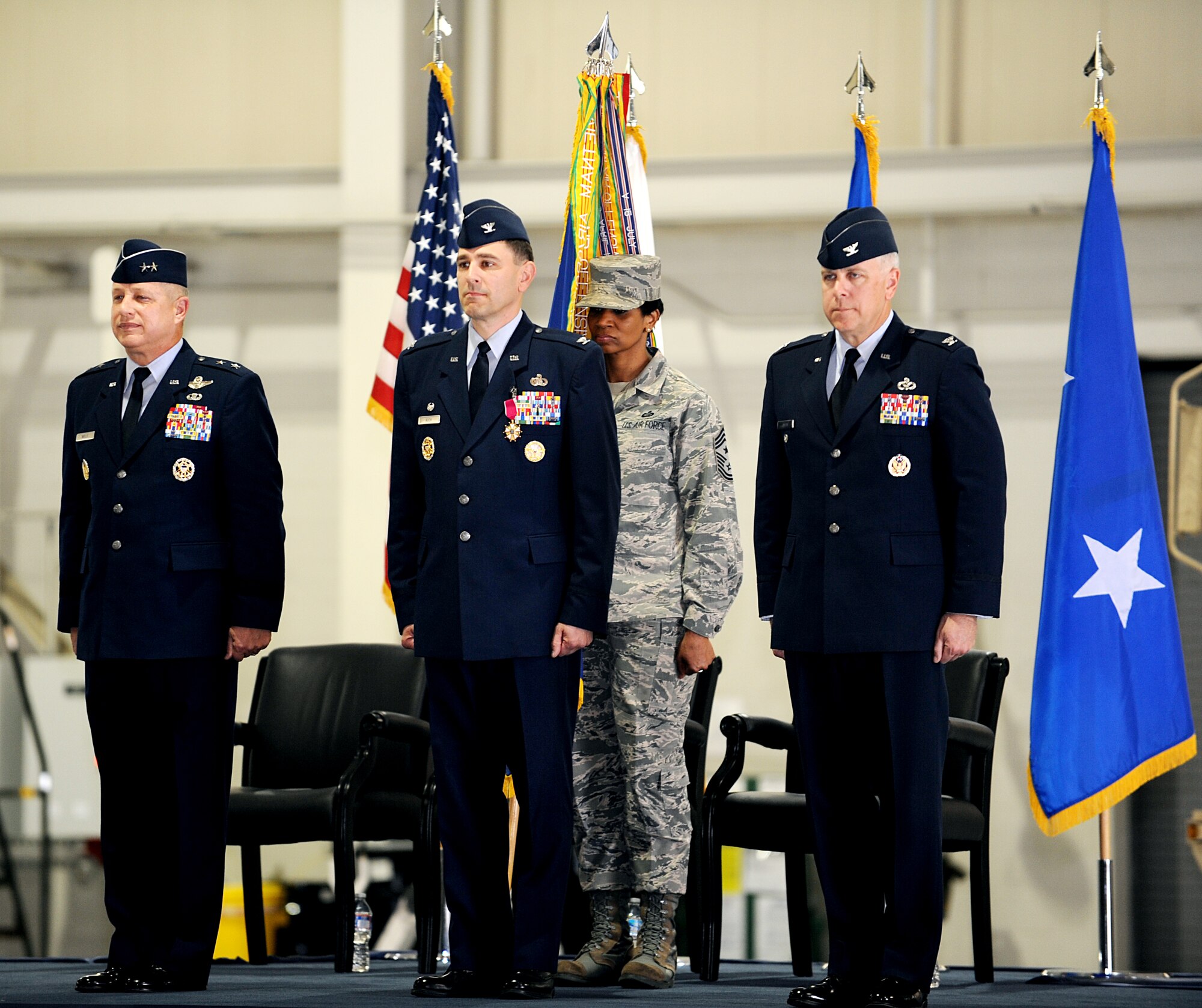 U.S Air Force Maj. Gen Lawrence Wells, 9th Air Force commander, Col. Korvin Auch, outgoing 633rd Air Base Wing commander, Chief Master Sgt. Trae R. King, 633rd ABW command chief, and Col. John J. Allen, incoming 633rd ABW commander, prepare to for the ceremonial guidon exchange during the 633rd ABW change of command ceremony on Langley Air Force Base, Va., April 22, 2013. Allen will assume command of the 633rd ABW. (U.S. Air Force photo by Airman 1st Class Kimberly Nagle/Released)