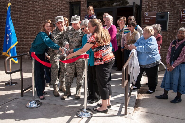 PETERSON AIR FORCE BASE, Colo. – (Left to right) Heather Donnithorne, wife of Lt. Col. Mark Donnithorne, 21st Civil Engineer Squadron commander, Chief Master Sgt. Richard Redman, 21st SW command chief, Col. Chris Crawford, 21st Space Wing commander, Sharon Hodges, Loan Locker lead volunteer, and Johnna Scobey, Airman’s Attic lead volunteer, cut a ceremonial ribbon April 12 opening the Airman’s Attic and Loan Locker’s new location in building 1525, across from the base chapel. The Loan Locker is open to PCSing service members and retirees of all ranks. Members can borrow items while waiting to leave Peterson or for their household goods to arrive. Airmen E-5 and below may pick up items at the Airmen’s Attic for free. Uniform items donated to the attic, however, are available for all ranks. Normal hours are 10 a.m.-2 p.m. Monday, Wednesday and Friday for the Airmen's Attic; 10 a.m.-2 p.m. Monday to Friday for the Loan Locker. For information call 556-3215 (Airman’s Attic) or 556-7614 (Loan Locker). (U.S. Air Force photo/Craig Denton)