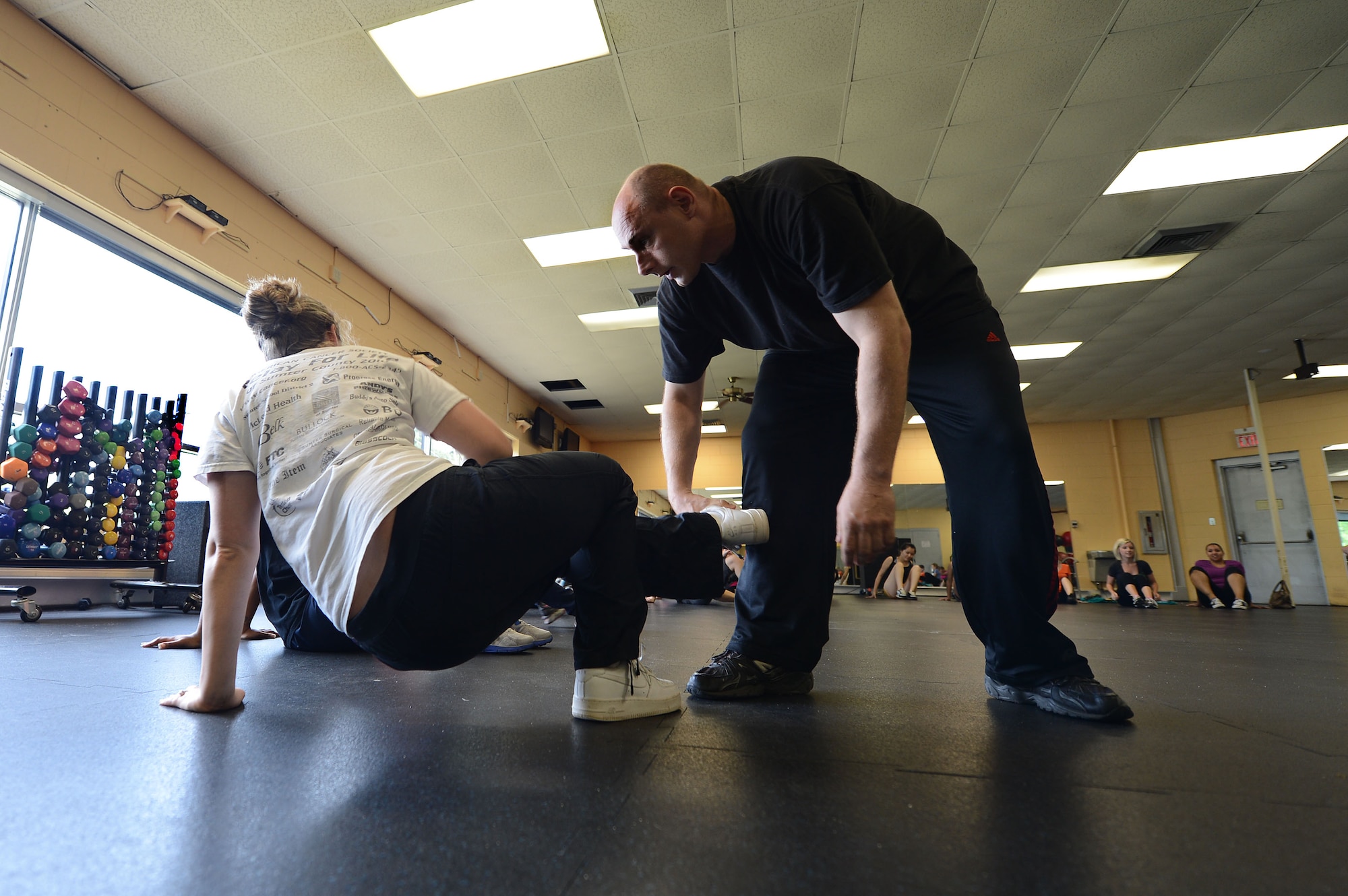 U.S. Air Force Master Sgt. Jamey Olsen, U.S. Air Forces Central Command mechanical subject matter expert, teaches Airmen, Soldiers, spouses and retirees quick ways to get off of the ground during an assault at the Fitness Center, Shaw Air Force Base, S.C., April 19, 2013.  Olsen taught 32 females different escape techniques during a self defense class.  The class is held annually by the Sexual Assault Response Program during April for Sexual Awareness month. (U.S. Air Force photo by Airman 1st Class Nicole Sikorski/Released)