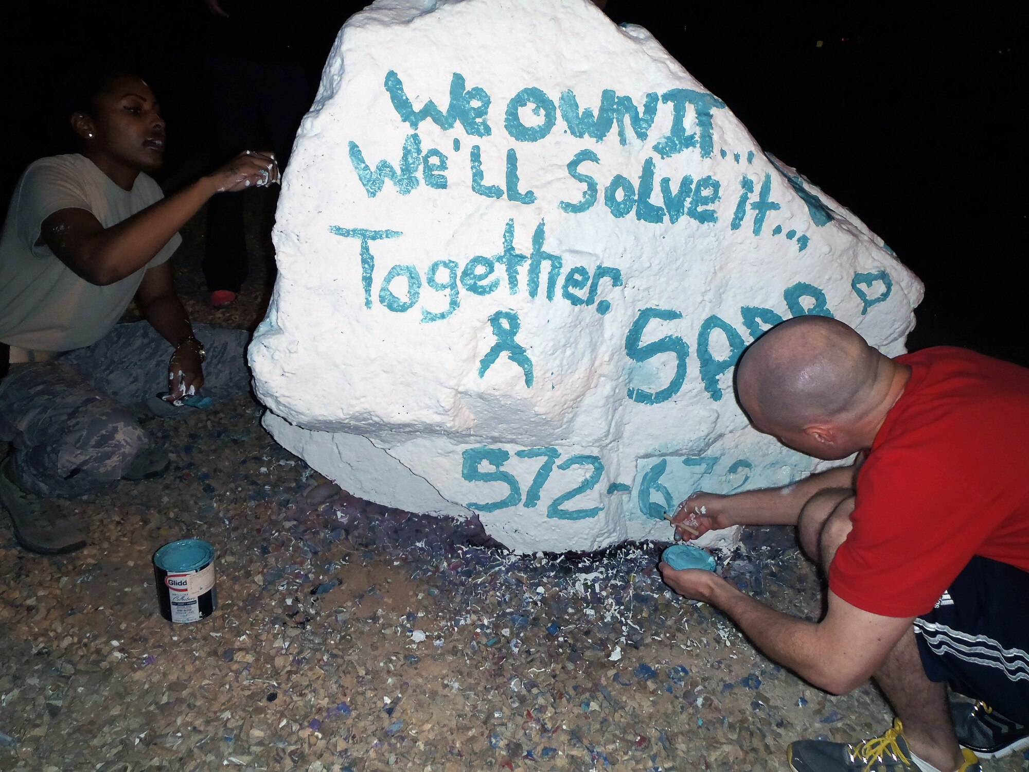 Airman 1st Class Ashley Green and Tech. Sgt. Carey Kane, both victim advocates at Holloman Air Force Base, N.M., paint the rock at the commanders’ circle April 13 in honor of Sexual Assault Awareness Month. There are 34 victim advocates at Holloman AFB. To report a sexual assault, call the 27/7 sexual assault response hotline at (575) 572-6789. (U.S. Air Force photo by Staff Sgt. Carolyn Herrick/Released)
