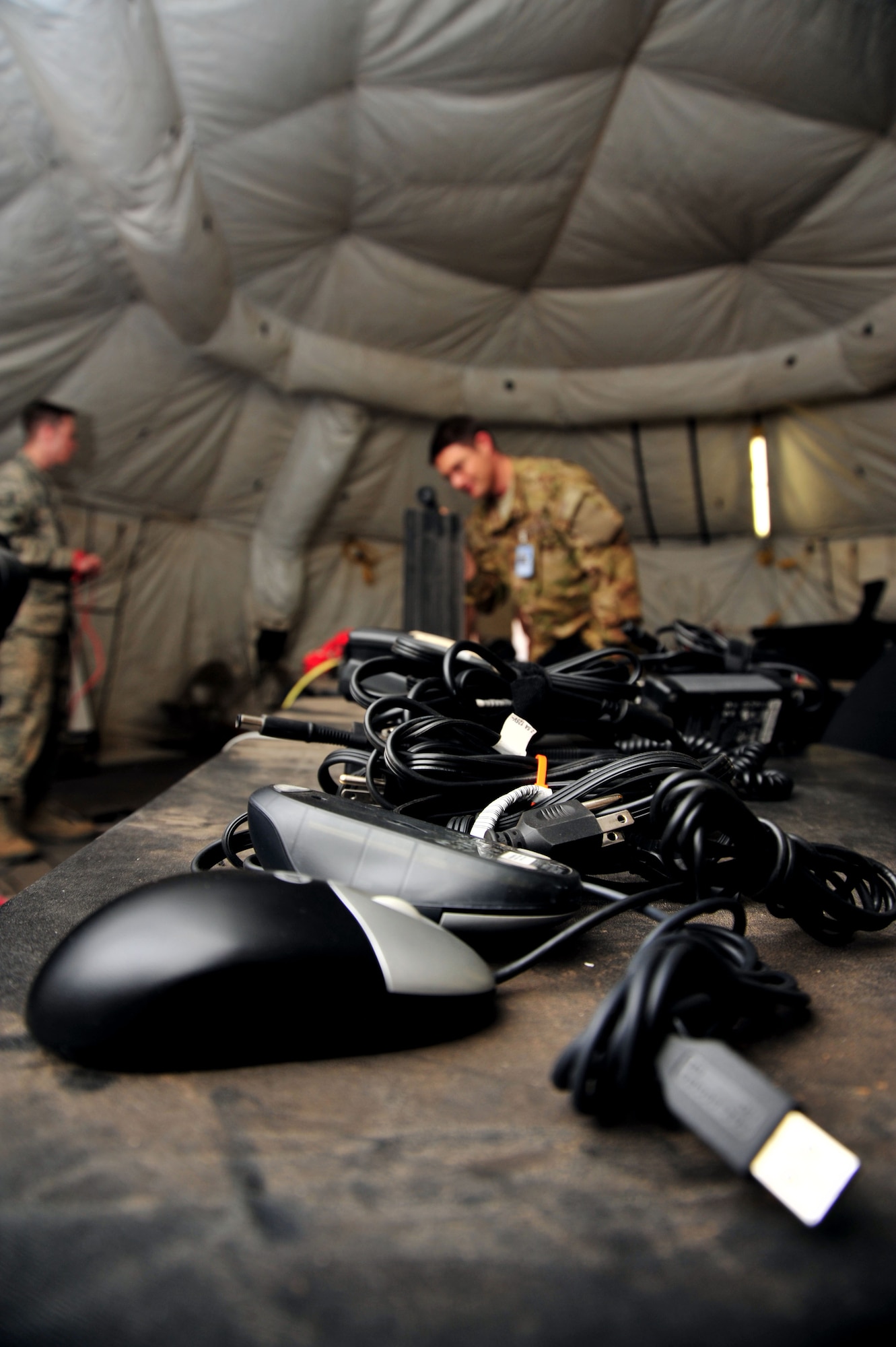 U.S. Air Force Airmen tear down communication systems after the Angel Thunder exercise at Davis-Monthan Air Force Base, Ariz., April 22, 2013. Angel Thunder is the world’s largest most realistic, joint service, multinational, interagency combat search and rescue exercise.(U.S. Air Force photo by Airman 1st Class Josh Slavin/Released)