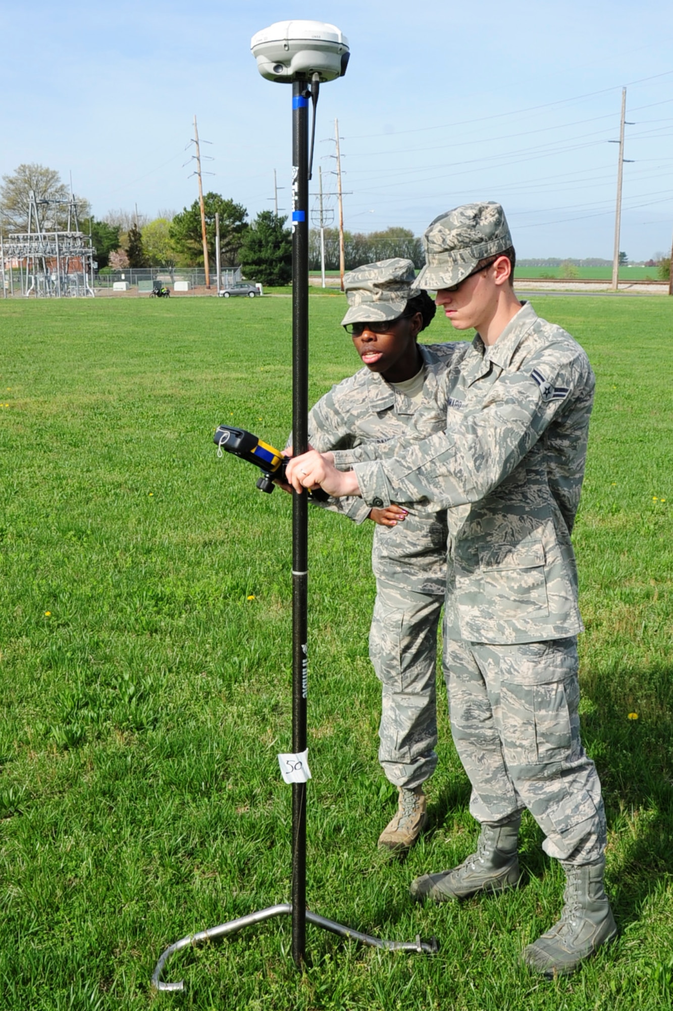 Members of the 436th Engineer Squadron Engineering Flight record a location of an aircraft part with the R8 3 GPS at a mock crash grid survey, April 17, 2013, at Dover Del. The training is part of an annual requirement. (U.S. Air Force photo/Senior Airman Jared Duhon)
