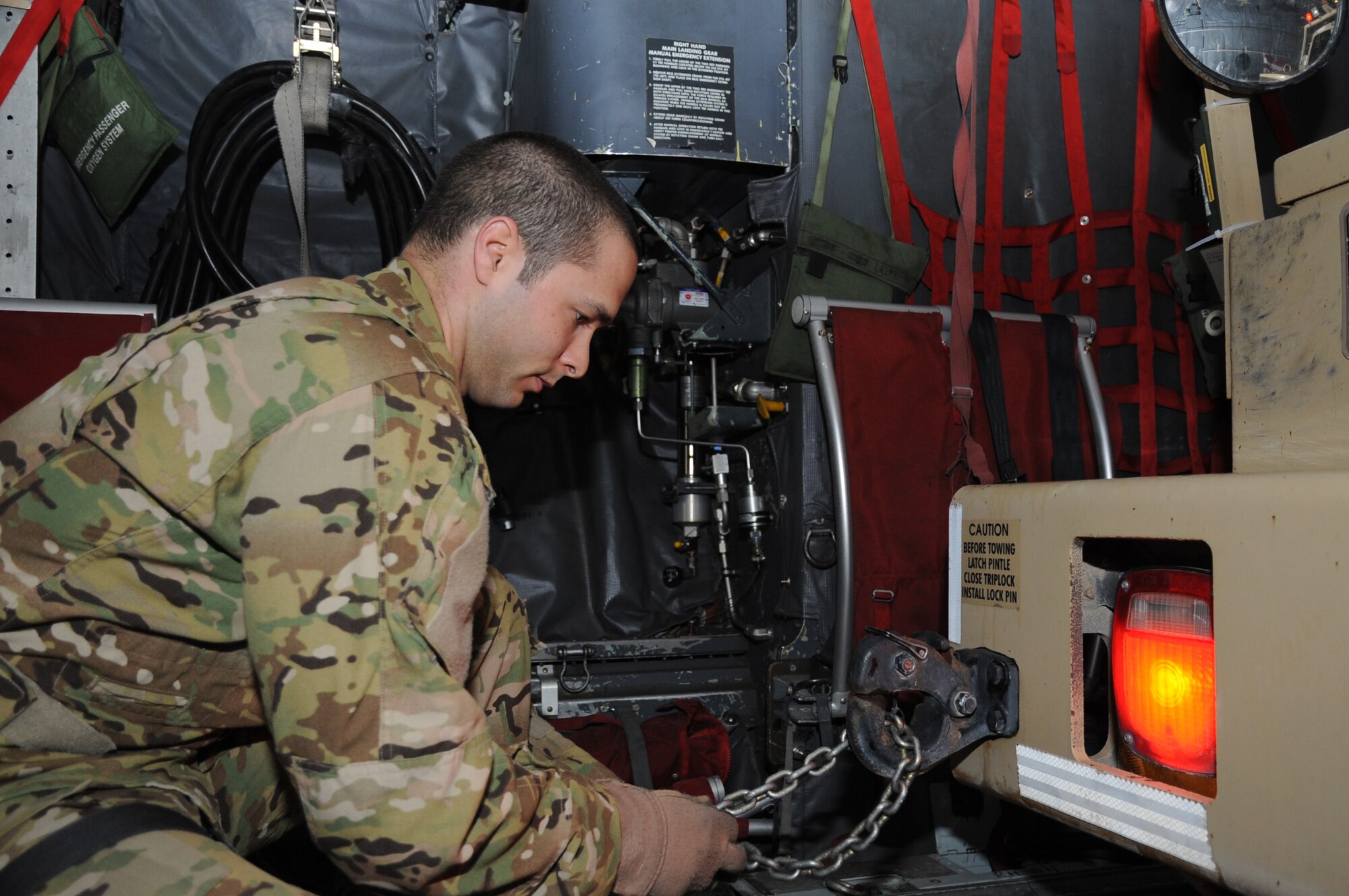 Staff Sgt. Vincent Telmanik, 774th Expeditionary Airlift Squadron loadmaster, secures a tractor truck loaded onto a C-130 cargo aircraft on Bagram Airfield, Afghanistan, April 23, 2013. When dealing with rolling stock, loadmasters are responsible for ensuring vehicles are positioned properly for securing to the floor of the aircraft. (U.S. Air Force photo/Staff Sgt. David Dobrydney)