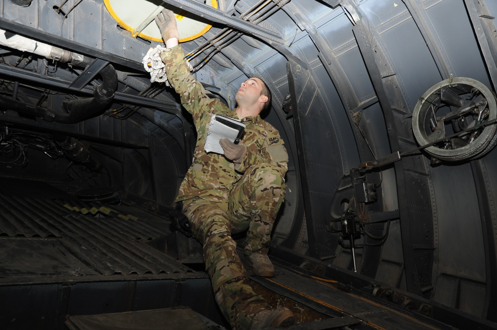 Staff Sgt. Vincent Telmanik, 774th Expeditionary Airlift Squadron loadmaster, performs a pre-flight inspection of a C-130 Hercules cargo aircraft on Bagram Airfield, Afghanistan, April 23, 2013. Loadmasters ensure the operability of aircraft systems and monitor the cargo while airborne. (U.S. Air Force photo/Staff Sgt. David Dobrydney)