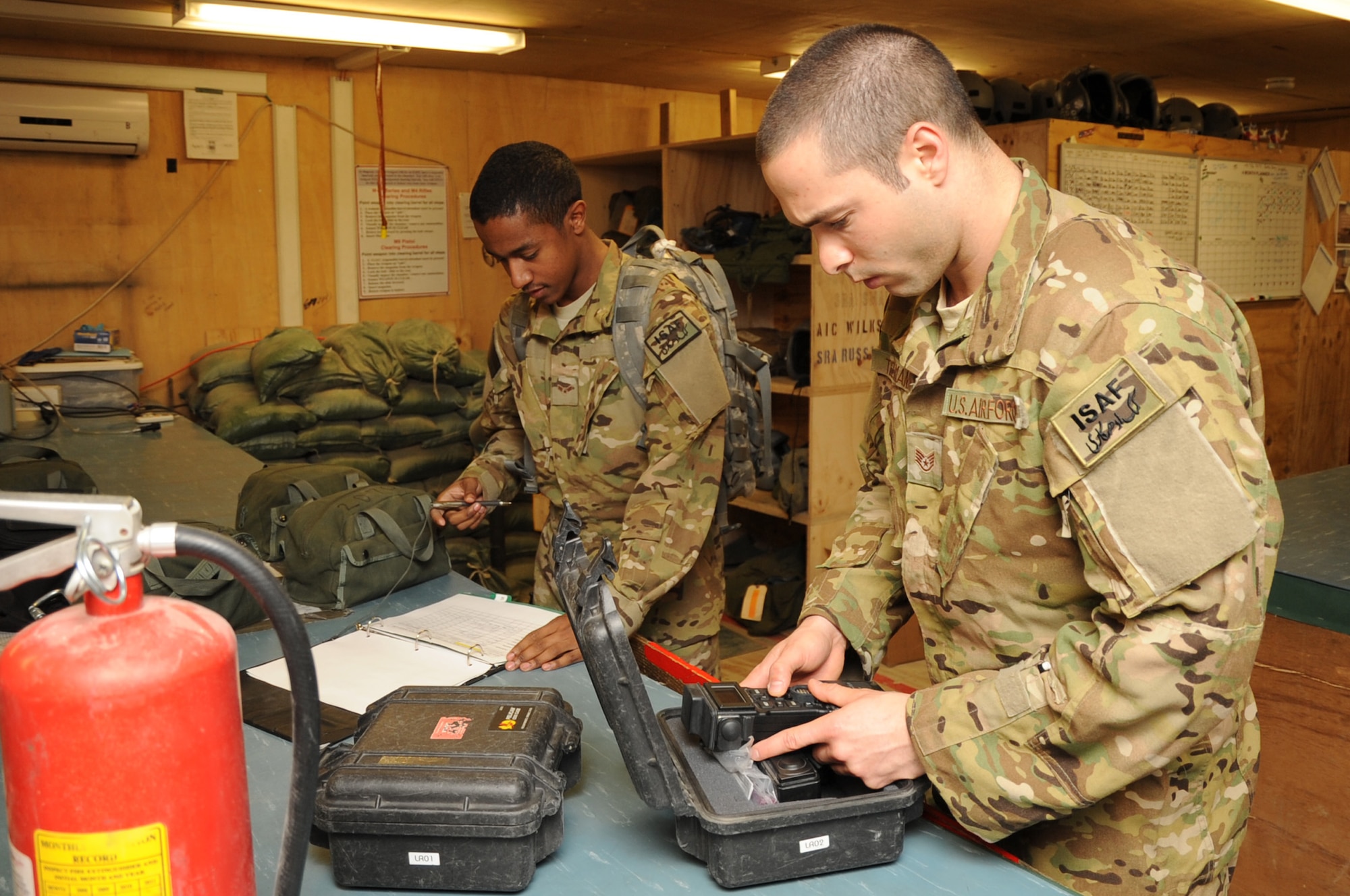 Airman 1st Class Michael Brown and Staff Sgt. Vincent Telmanik, 774th Expeditionary Airlift Squadron loadmasters, sign out and check equipment in preparation for a mission on Bagram Airfield, April 23, 2013. Loadmasters are responsible for ensuring cargo is properly secured for flight. (U.S. Air Force photo/Staff Sgt. David Dobrydney)