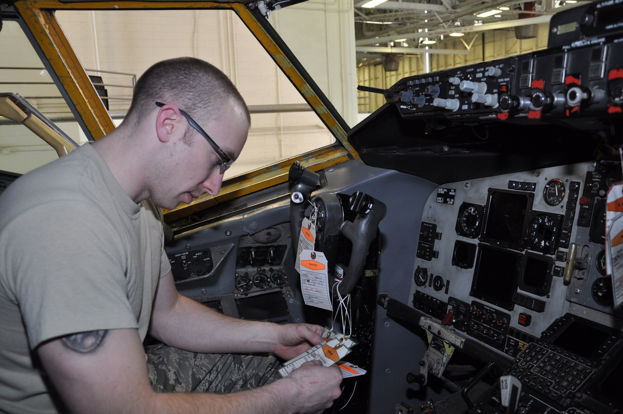 Staff Sgt. Ryan McPartland, a maintainer from the Repair and Reclamation section, 931st Maintenance Squadron pulls the maintenance tags from the yoke of a KC-135 Stratotanker during routine scheduled maintenance, April 22. The tags ensure maintainers who are working on multiple aircraft sections, are cognizant of each others' activities. (Air Force photo by Master Sgt. Brannen Parrish)