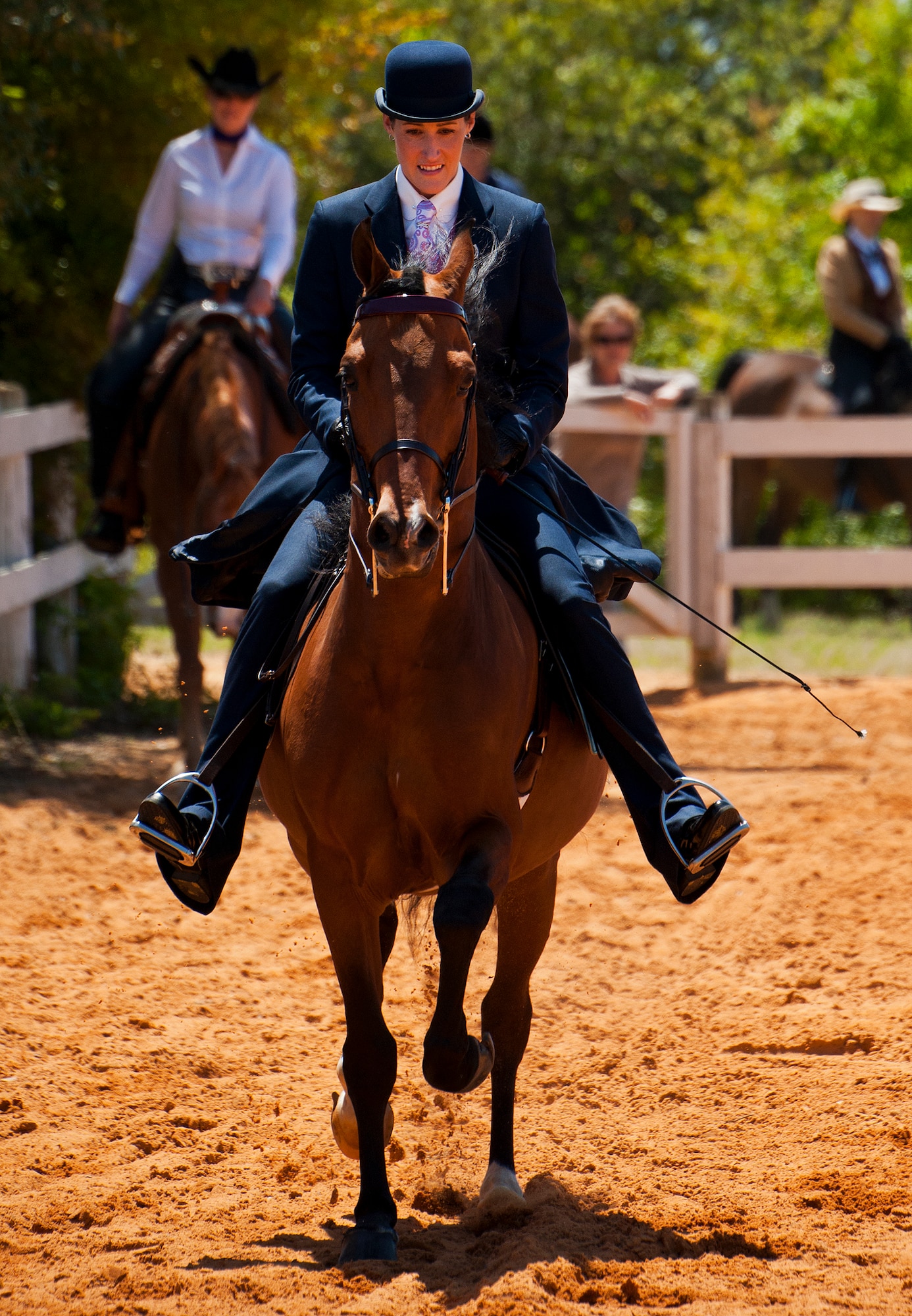 Riders enter the demonstration ring to show off various riding styles with their horses at the Sand and Spur Riding Club open house event April 20 at Eglin Air Force Base, Fla.  The club provided pony rides for kids and riding and training demonstrations. Those who attended got an up close and hands-on experience with many of the different breeds of horses housed at the stables on base.  (U.S. Air Force photo/Samuel King Jr.)