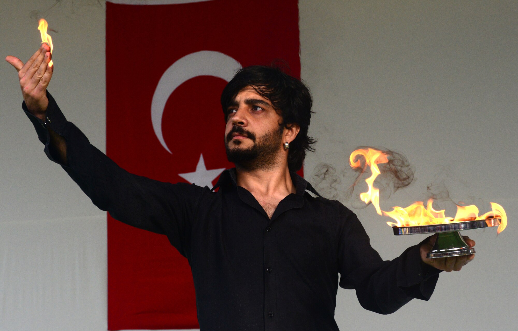 A magician holds a flame in his hand during a magic show as part the Children’s Day Festival activities April 21, 2013, at Arkadas Park, Incirlik Air Base, Turkey. Children's Day is a national holiday that honors Turkish children and the future of the country. In 1979, the United Nation’s Year of the Child and the Turkish government proposed April 23 be declared a holiday for children of the world. That same year, Turkey began inviting children from every country to participate in Children’s Day festivities. (U.S. Air Force photo by Staff Sgt. Eric Summers Jr./Released)