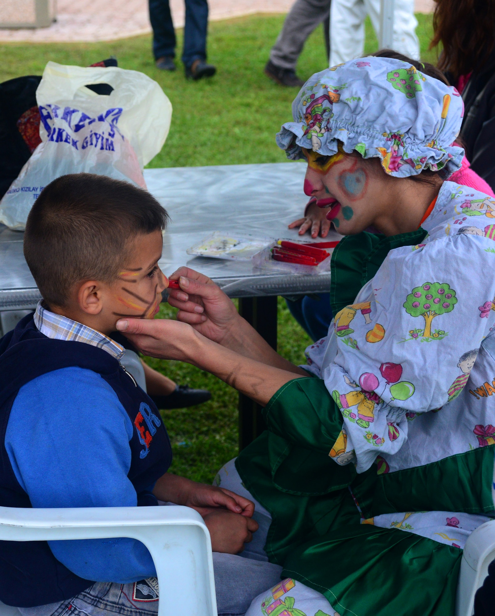 A woman paints the face of a young boy during the Children’s Day Festival April 21, 2013, at Arkadas Park, Incirlik Air Base, Turkey. The event offered an opportunity for camaraderie and building partnership between Turkish and American service members and civilians. In 1979, the United Nation’s Year of the Child, the Turkish government proposed April 23 be declared a holiday for children of the world. That same year, Turkey began inviting children from every country to participate in Children’s Day festivities. (U.S. Air Force photo by Staff Sgt. Eric Summers Jr./Released)