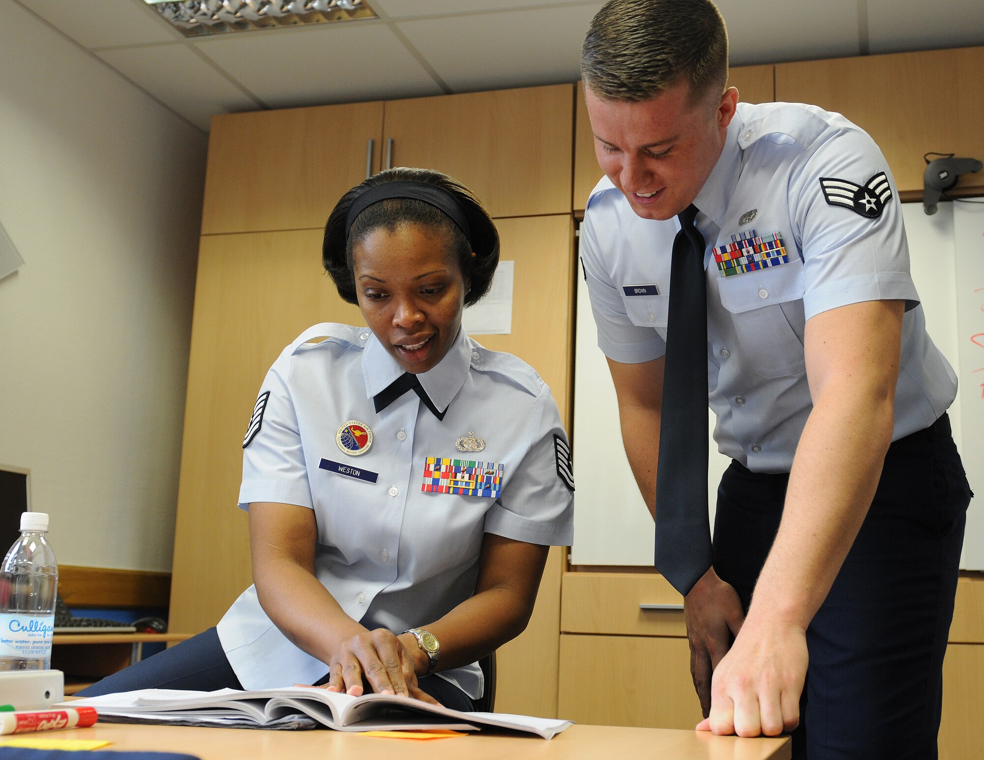 Tech. Sgt. Judy Weston, 86th Force Support Squadron Ramstein Airman Leadership School instructor, explains operations security to Senior Airman Matthew Brown, 86th Munitions Squadron munitions system technician, April 22, 2013, Kapaun, Germany. Brown was recently awarded the Conventional Munitions Systems Maintainer Technician of the Year for U.S. Air Forces in Europe and Air Forces Africa. (U.S. Air Force photo/Airman 1st Class Holly Cook)