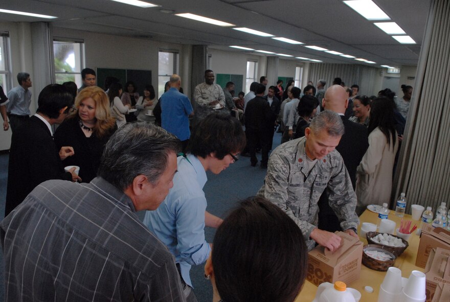 U.S. Air Force Chaplain (Maj.) Randy Sellers, 18th Wing chaplain, pours juice for visiting Okinawan religious leaders at the Kadena Chaplain Corps' clergy day on Kadena Air Base, Japan, April 19, 2013. The chaplains and their assistants created a full day of activities for their visitors.  (U.S. Air Force photo by Staff Sgt. Lauren Snyder/Released)
