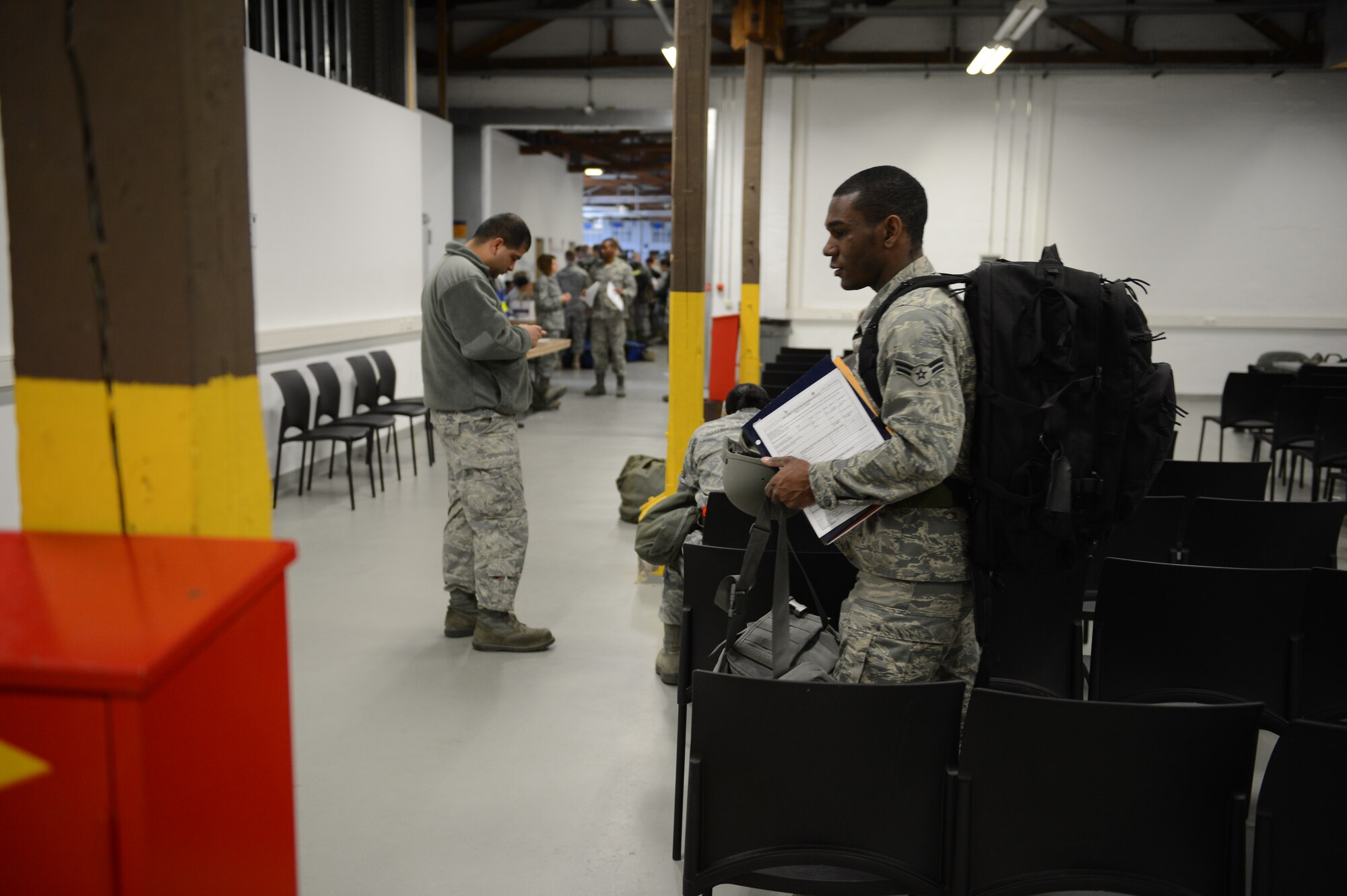 SPANGDAHLEM AIR BASE, Germany – U.S. Air Force Airman 1st Class Daniel Taylor carries his belongings before processing the Personnel Deployment Function line here April 4, 2013. This is Taylor’s first deployment since he joined the Air Force. (U.S. Air Force photo by Staff Sgt. Nathanael Callon/Released)