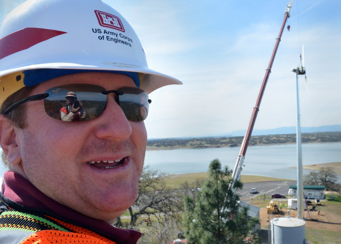 Jonathan Friedman, senior district natural resource specialist for the Sacramento District, looks on as an 11kW wind turbine is assembled at Black Butte Lake park. 