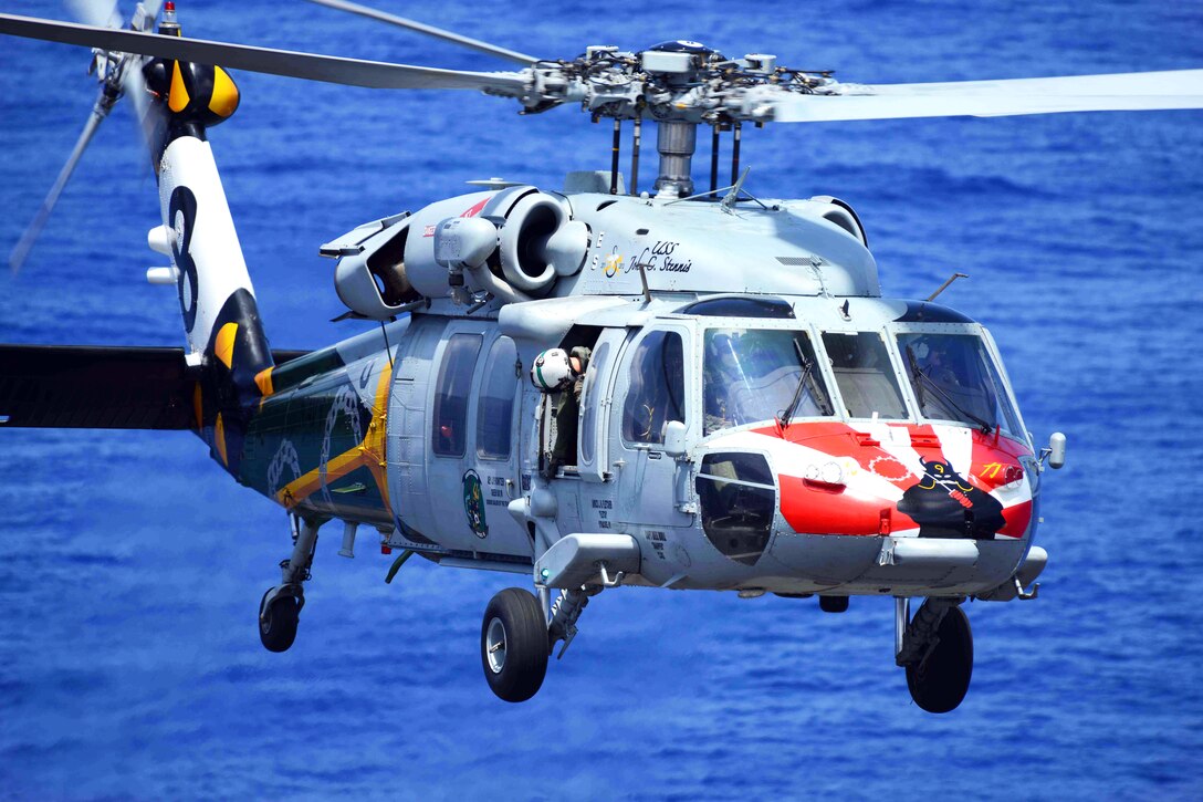 An MH-60S Seahawk helicopter assigned to Helicopter Sea Combat Squadron 8 hovers over the flight deck during a demonstration aboard the USS John C. Stennis underway in the Pacific Ocean, April 20, 2013.