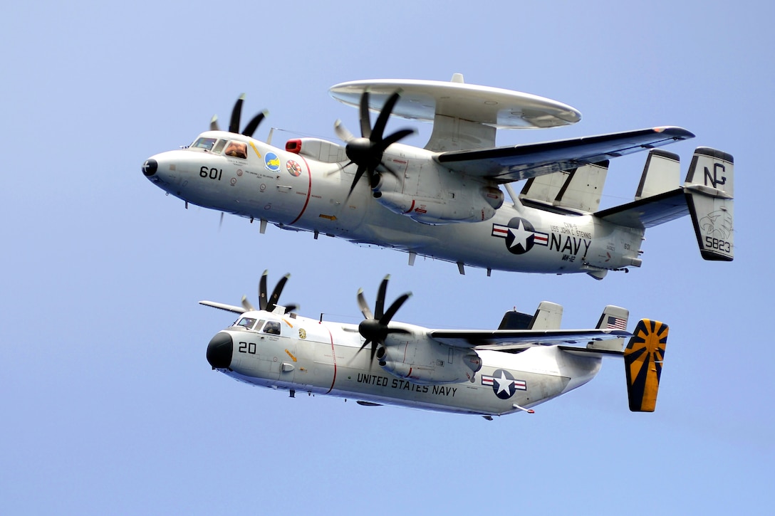 An E-2C Hawkeye, top, assigned to Airborne Early Warning Squadron 112 and a C-2A Greyhound assigned to Fleet Logistics Combat Support Squadron 30 fly in formation during a demonstration above the USS John C. Stennis underway in the Pacific Ocean, April 20, 2013.
