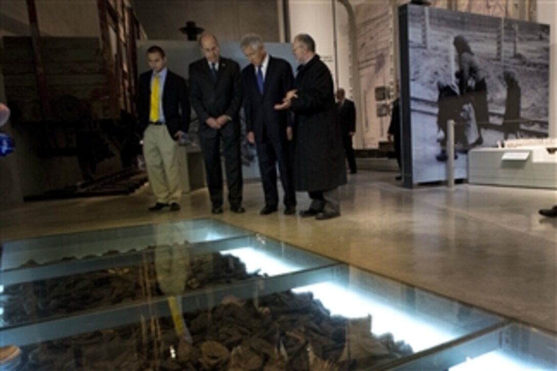 Director of Libraries at Yad Vashem Robert Ozzett, right, explains an exhibit to Secretary of Defense Chuck Hagel, second from right, Israeli Minister of Defense Moshe Ya'alon, third from right, and Ziller Ozzett during a tour of Yad Vashem in Jerusalem, Israel, on April 21, 2013.  Yad Vashem is Israel’s official memorial to the Jewish victims of the Holocaust.  Hagel will spend several days in Israel meeting with counterparts on a six-day trip to the Middle East.  