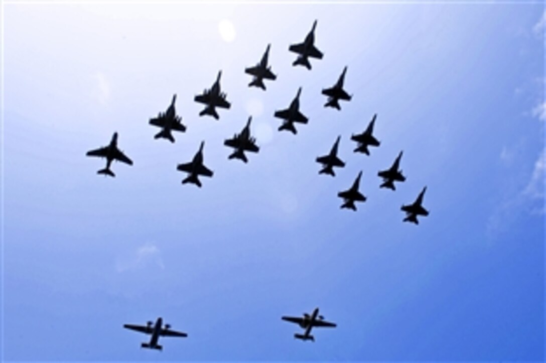 Aircraft fly in formation during a demonstration above the aircraft carrier USS John C. Stennis in the Pacific Ocean, April 20, 2013. The aircraft are assigned to the John C. Stennis Carrier Strike Group, which is returning from an eight-month deployment in areas of responsibility for the U.S. 5th and 7th fleets.