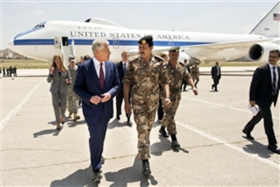 U.S. Defense Secretary Chuck Hagel, left, walks with Gen. Mashal al-Zaben, Jordanian chairman of defense, in Amman, Jordan, April 23, 2013. Hagel is on a six-day trip to the Middle-East, where he is visiting foreign counterparts in Israel, Jordan, Saudi Arabia, Egypt and the United Arab Emirates.