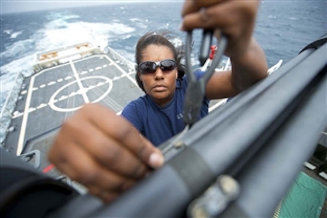 A Coast Guard seaman aboard the Coast Guard Cutter Stratton troubleshoots a radar system on the cutter's bridge while underway in the Pacific Ocean, April 19, 2013. 
